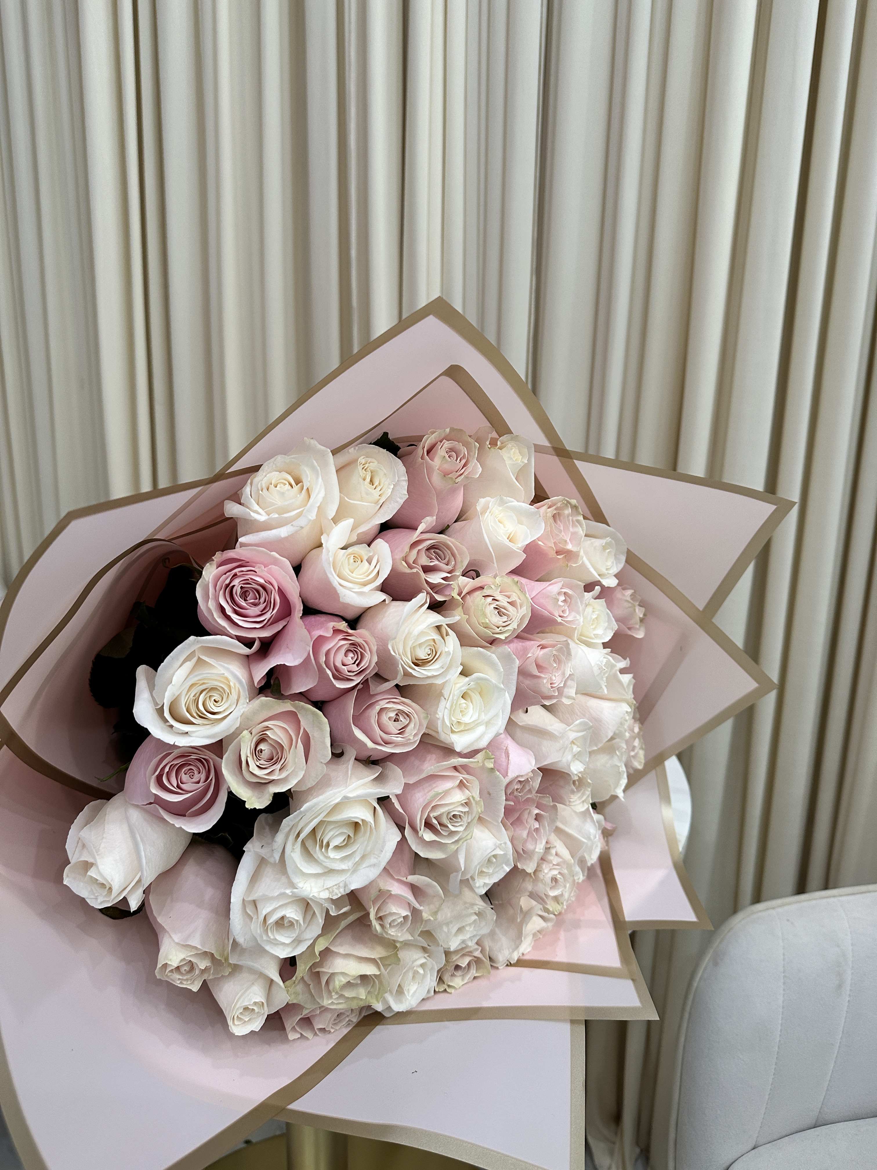  Double the Love - Express your love in full bloom with this delightful bouquet. Featuring 25 pink roses and 25 white roses, this arrangement is a symbol of enduring love and affection.