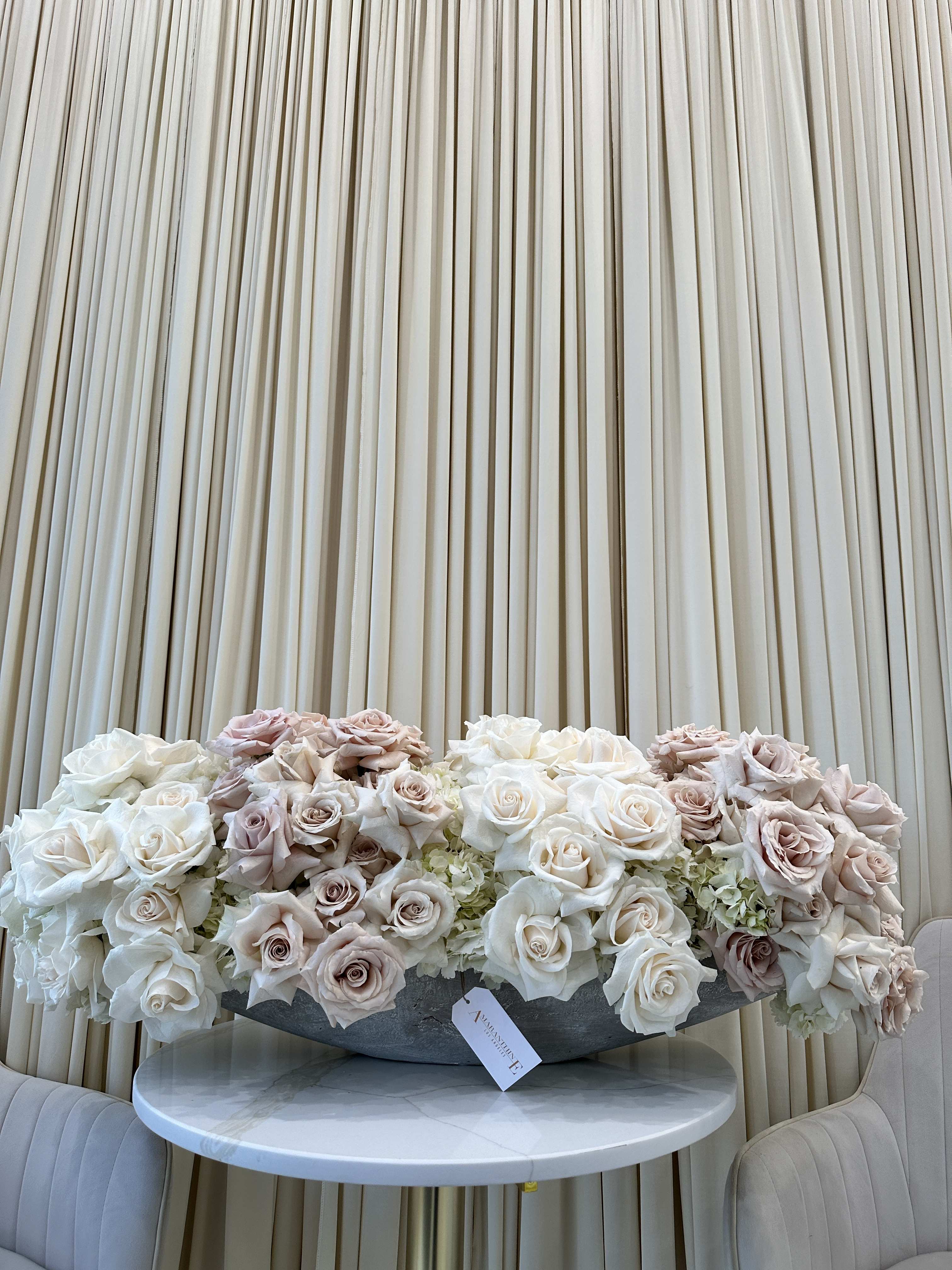 Blushing Beauty - Symbolize purity and love with this classic bouquet of white and blush roses. This arrangement is the perfect way to express your heartfelt emotions to someone special.  
