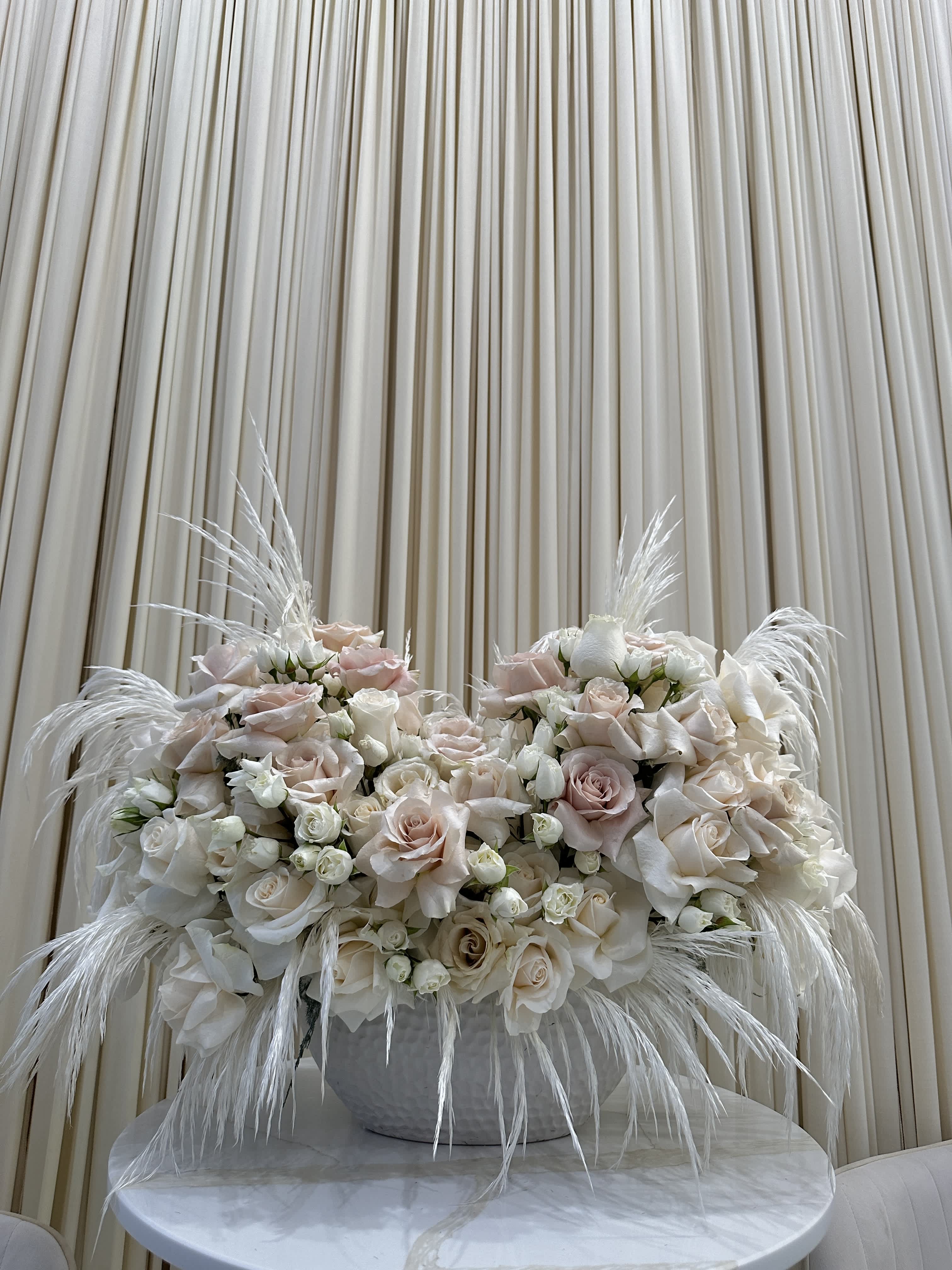 Cashmere Comfort - The soft, cashmere-hued blooms of this bouquet will create a feeling of warmth and comfort in your home. Featuring off-white roses, spray roses, and filler flowers, this arrangement is pure elegance.  