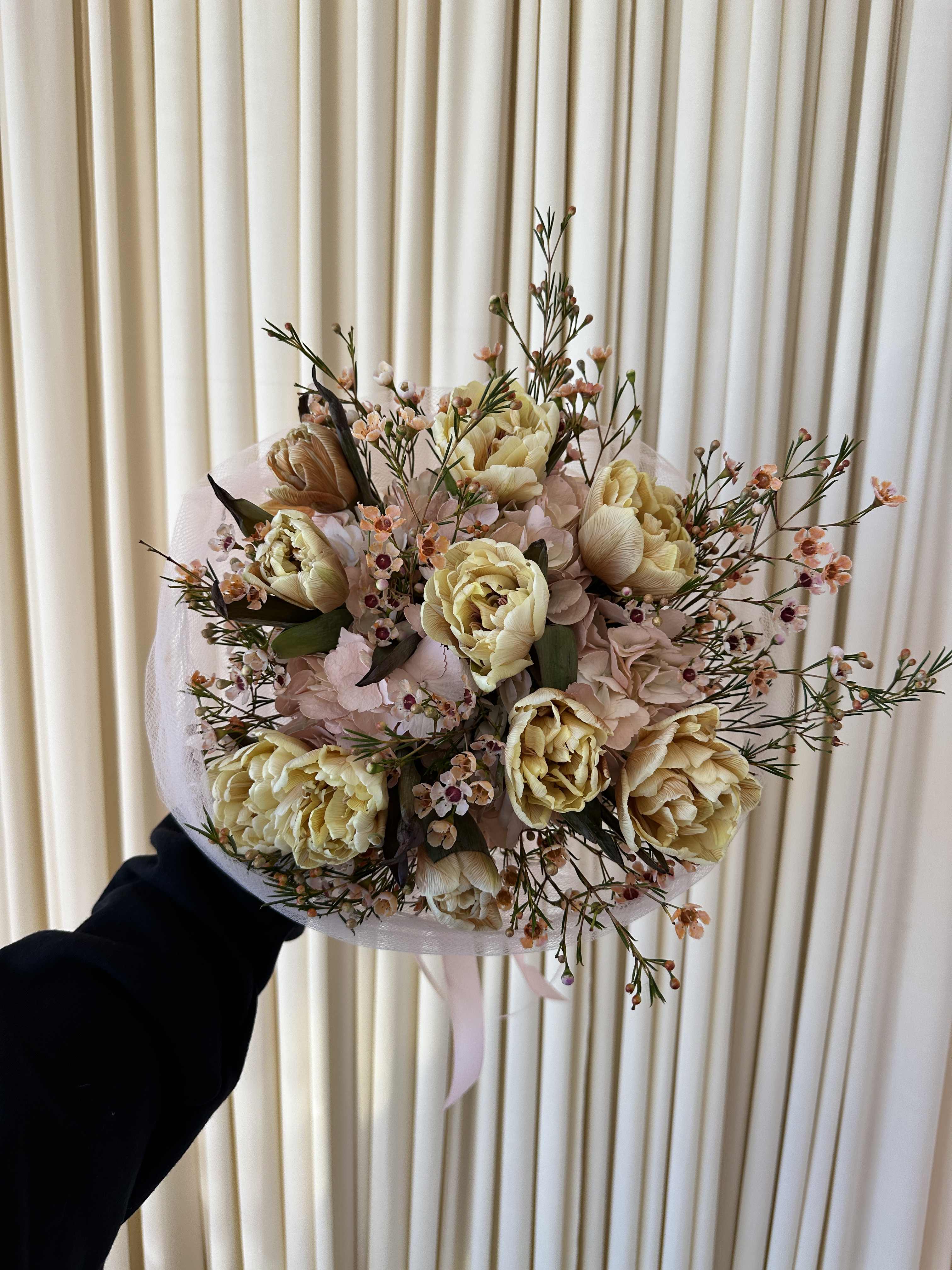 The Ballerina Bouquet - Soft and graceful, this bouquet of tulips, colored in delicate shades of antique yellow and wrapped in a wispy pink tulle, resembles a ballerina's tutu. It's a charming and unforgettable gift.