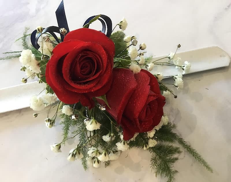 Red Rose Wrist Corsage - Two Red Roses with Baby's Breath and Greenery.  As shown with Black Ribbon.  If you would like a different ribbon color, please indicate so in the special instructions when checking out.