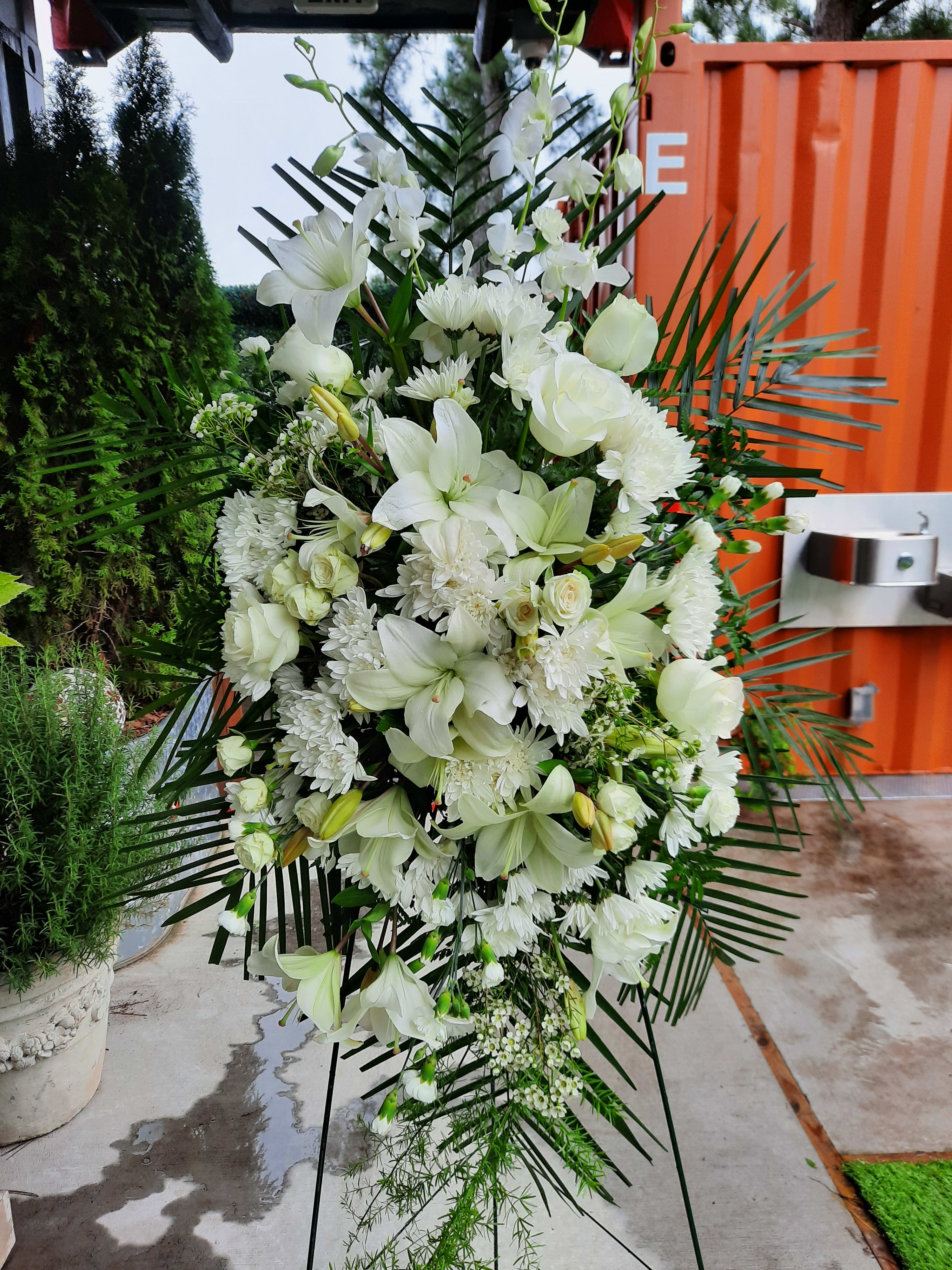 Royal Rest Standing Spray - A standing spray with varied white flowers, greenery in tasteful design. 