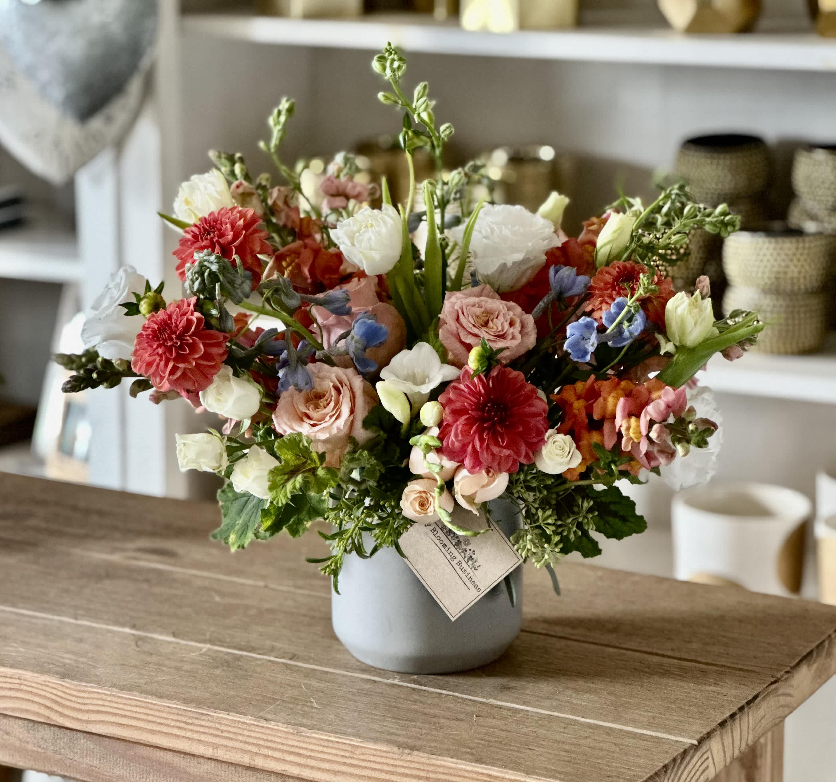 Hey There Gorgeous  - Hey There Gorgeous arrangement s a grey vase filled with Oranges, Peach, Cream colored florals with a hint of Blue. This is an arrangement that is perfect for any occasion to send to friends and loved ones.  