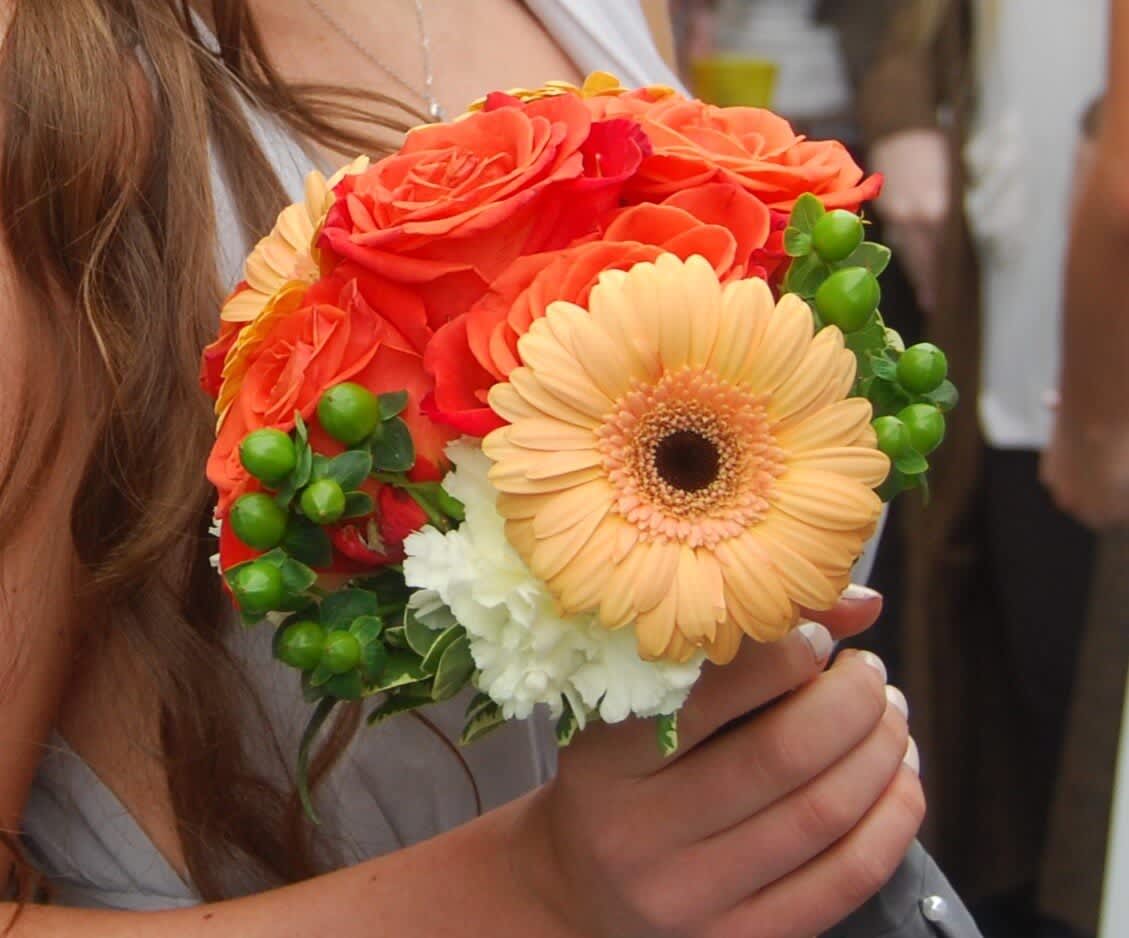 Sweet Citrus Bouquet Sweet Citrus Bouquet - A Subtle mix of Roses, Gerbera Daisies, Hypericum, and carnations. Looking for a different color palette, please let us know in the special instructions what colors you are looking for.
