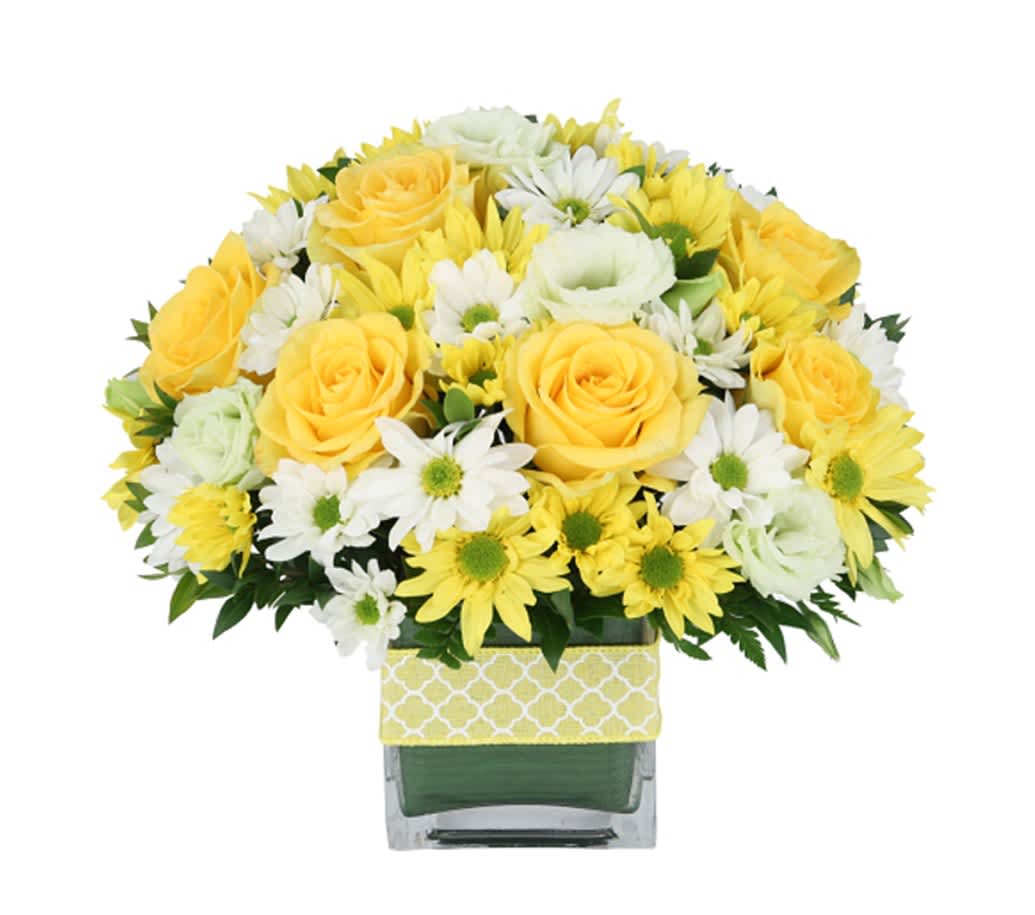 Rise and Shine - The perfect centerpiece for a breakfast table, or simply a kind gesture for a friend or loved one.  This ray of sunshine arrangement includes yellow roses, white daisies and yellow daisies beautifully arranged in a square glass vase.
