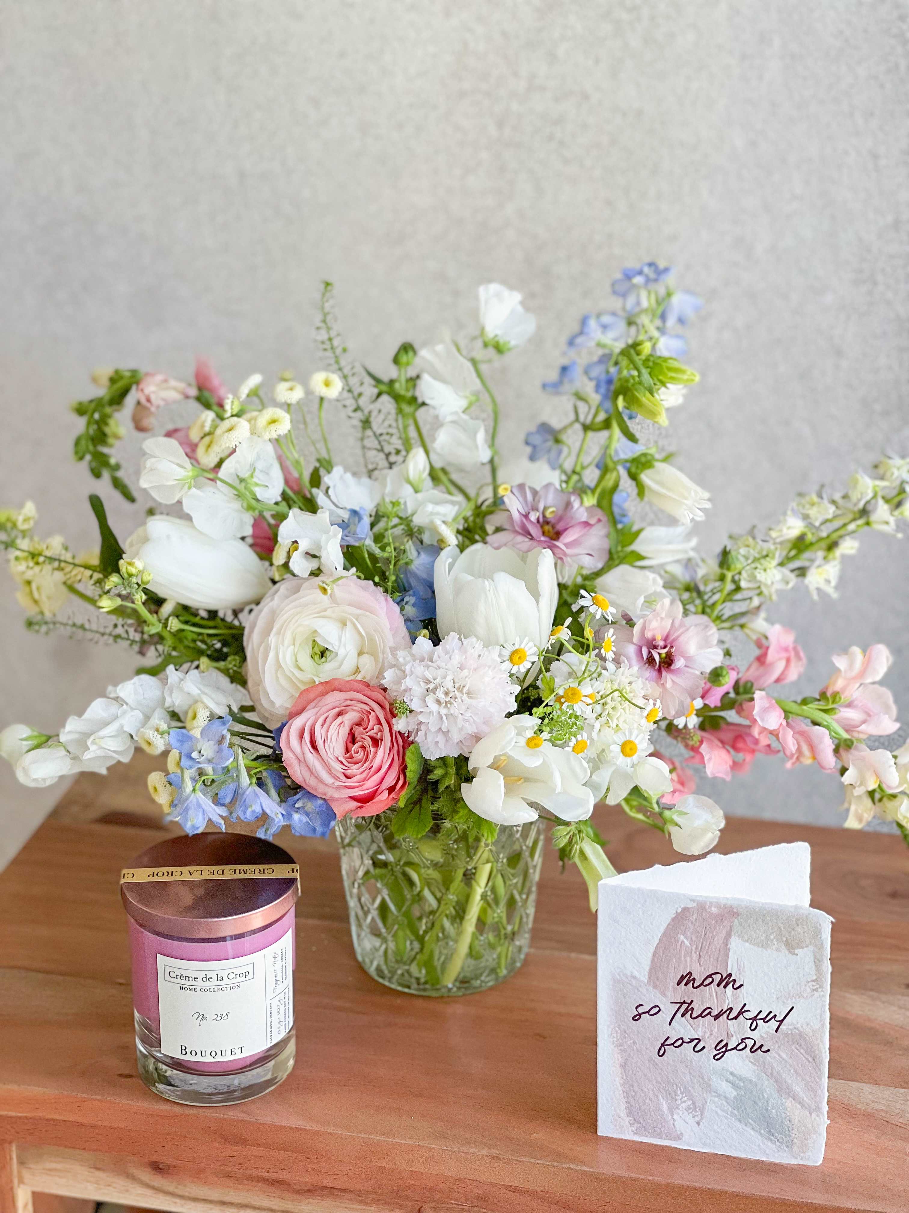 Mother's Day Arrangement + Candle  - A gift every mom will LOVE! A seasonal Designer's Choice arrangement paired with a soy candle. Mother's day Card included!  