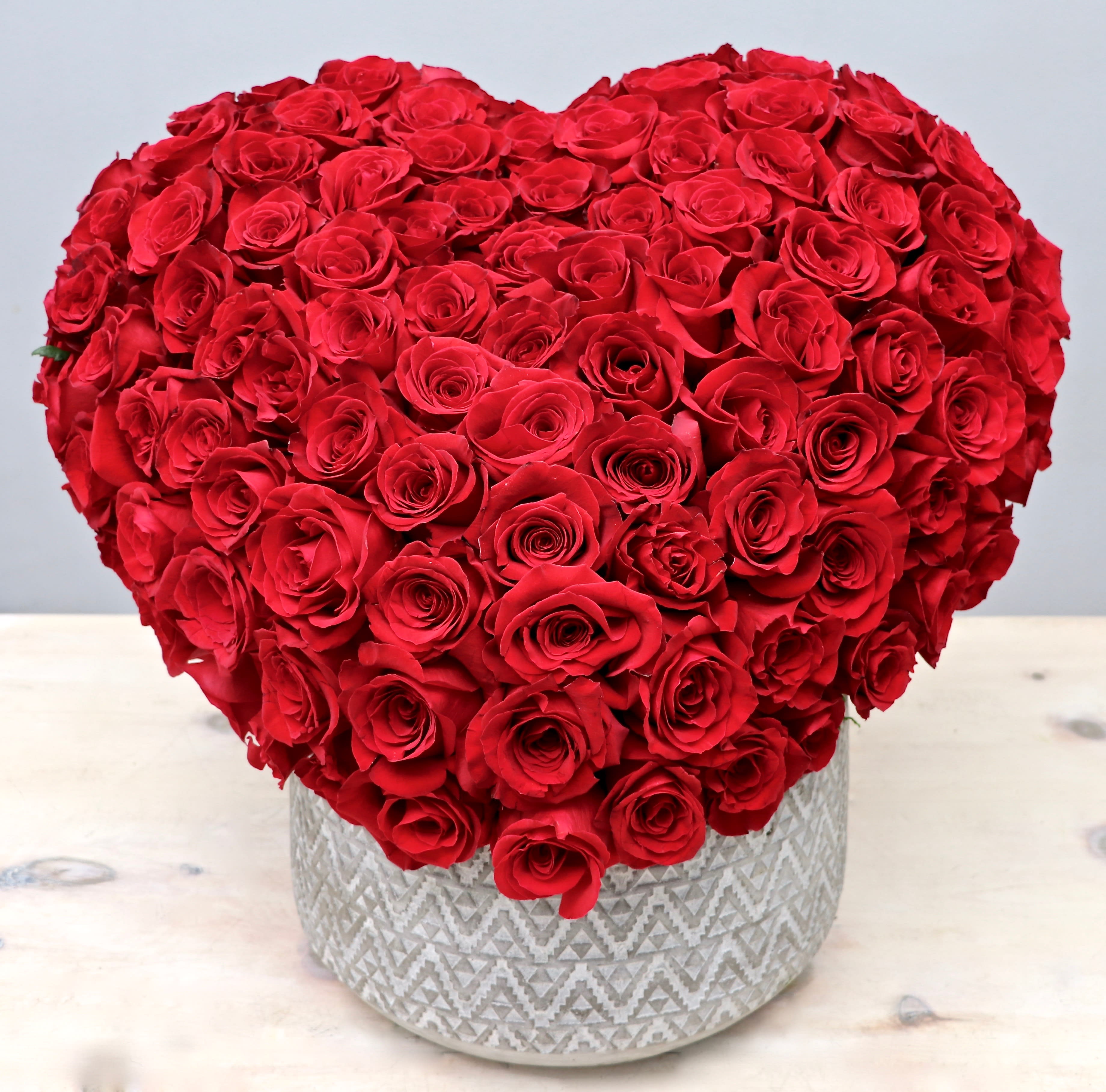 Heart Valentine - Glendale Florist - This hand crafted heart arrangement consists of 100 premium red roses. Make sure to upgrade to deluxe or premium to make this arrangement even more of a statement. Deluxe size holds 125 roses, while premium size holds 150 roses.  Let us know what color you would like in the florist instructions box at checkout. 