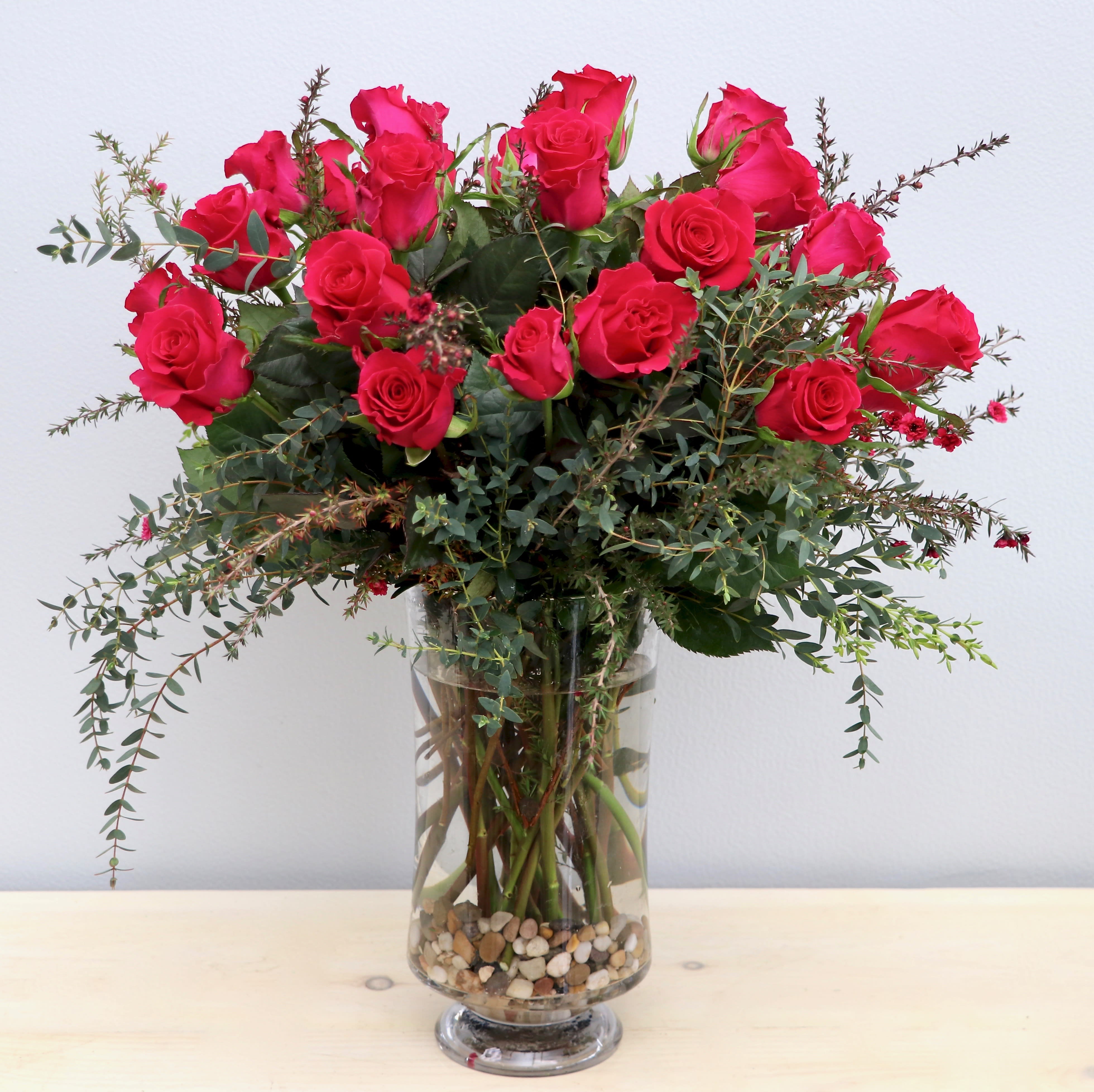 Pink Lady  - Glendale Florist - Hot pink roses make this arrangement the pink beauty everyone deserves.  Standard has  24 roses. Deluxe has 50 roses. Premium has 100 roses. 