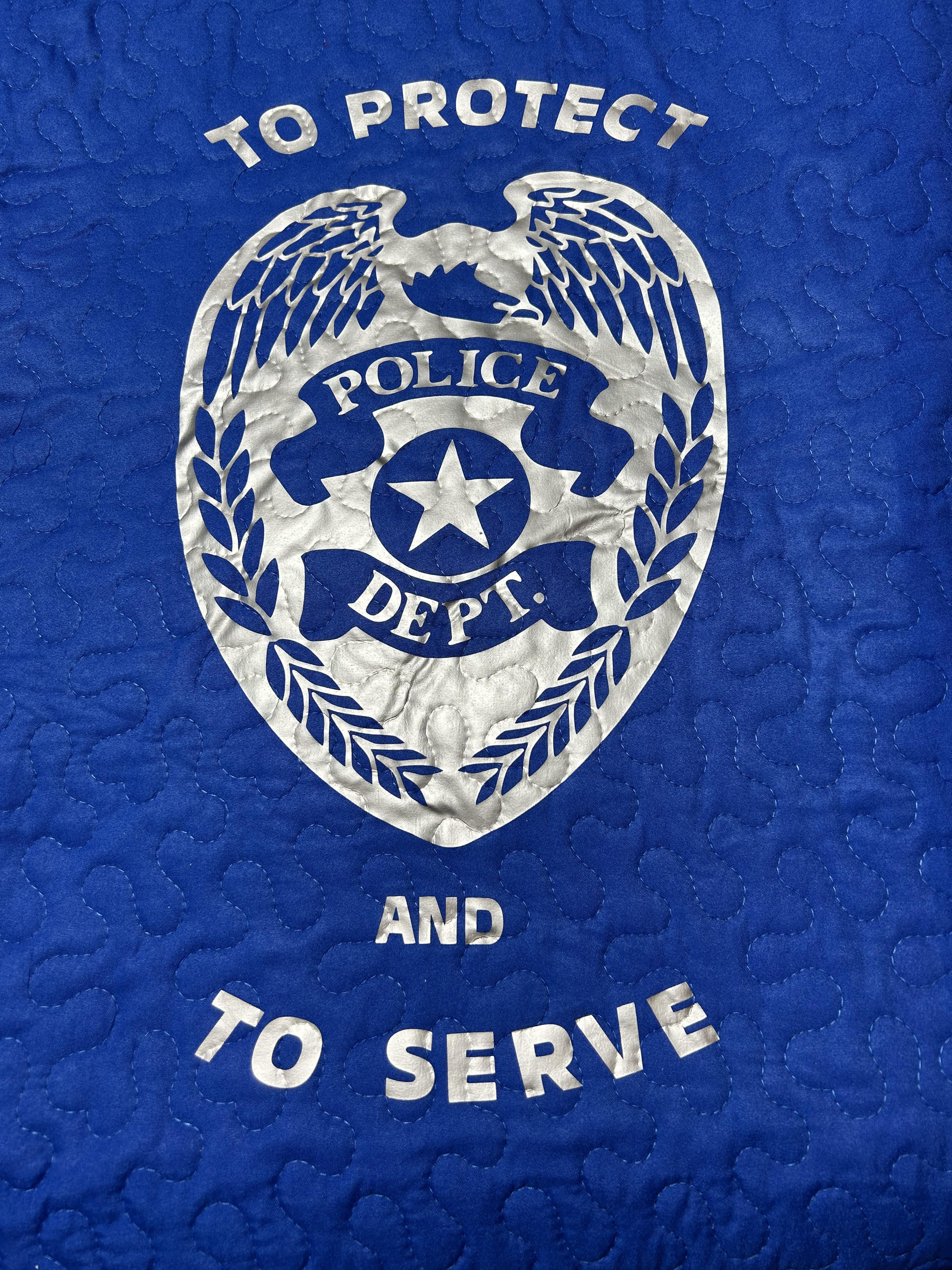 To Protect and To Service Police Quilted Throw - This Quilt would be the perfect gift for a retiring police officer, for the family of an officer that has passed on or birthday. Quilt has scalloped edging and is 50 x 60 in size.   Easel is 15.00 extra, Choose Deluxe to add easel to order for presentation. 
