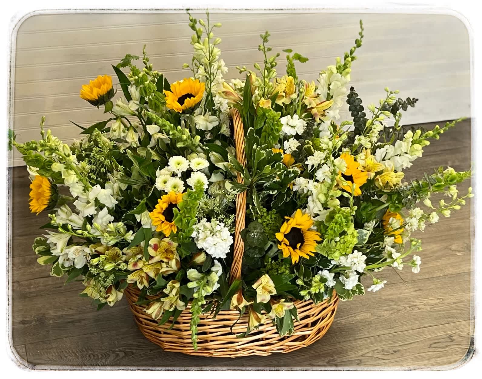 Basket of Sunshine - This is a basket of yellow and white flowers. This is a sympathy arrangement.