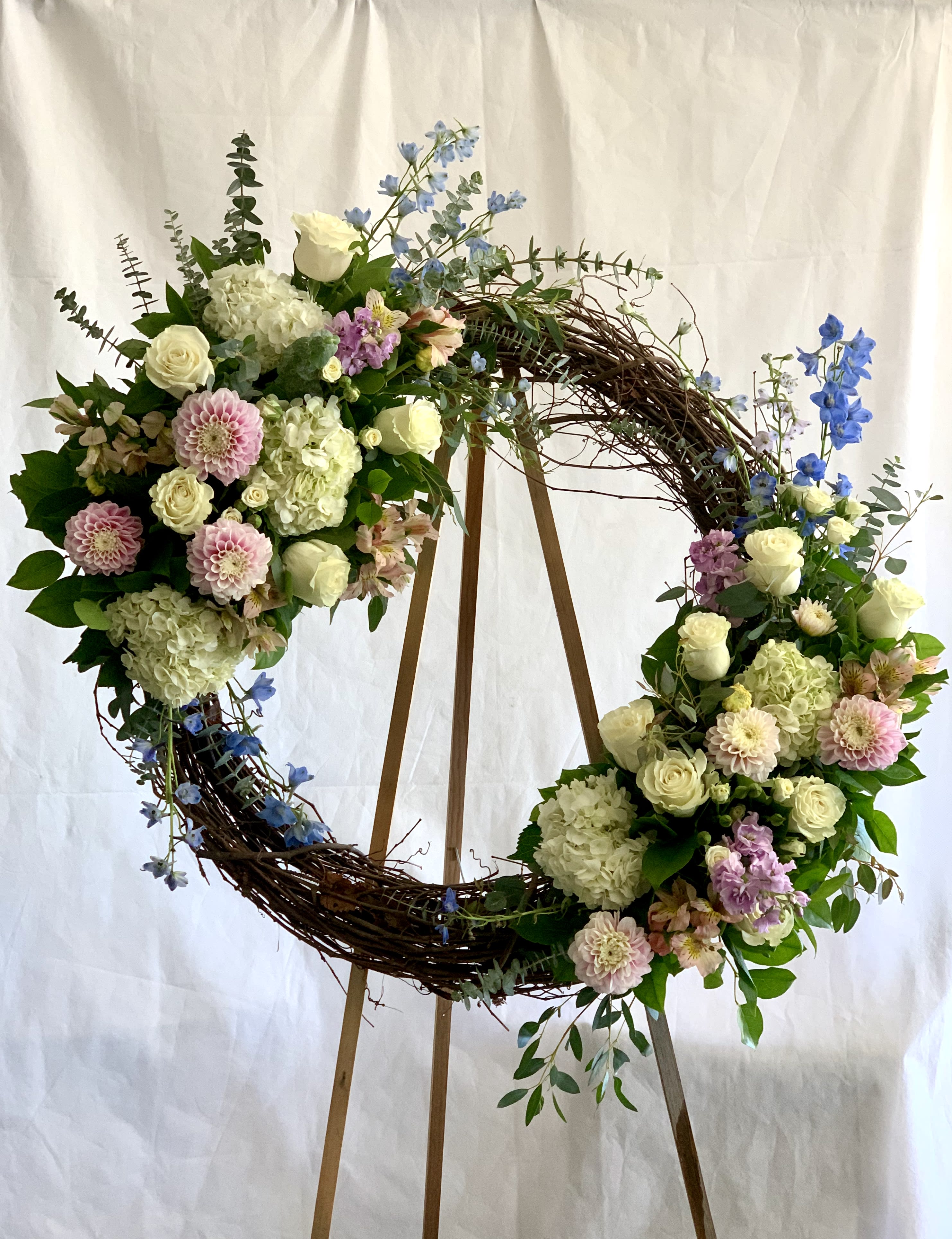 Curly Willow Remembrance - A designers choice of your preferred colors woven into a natural tree branch wreath.  Picture reflects Deluxe version.  Please specify preferred color palette in the special instructions.