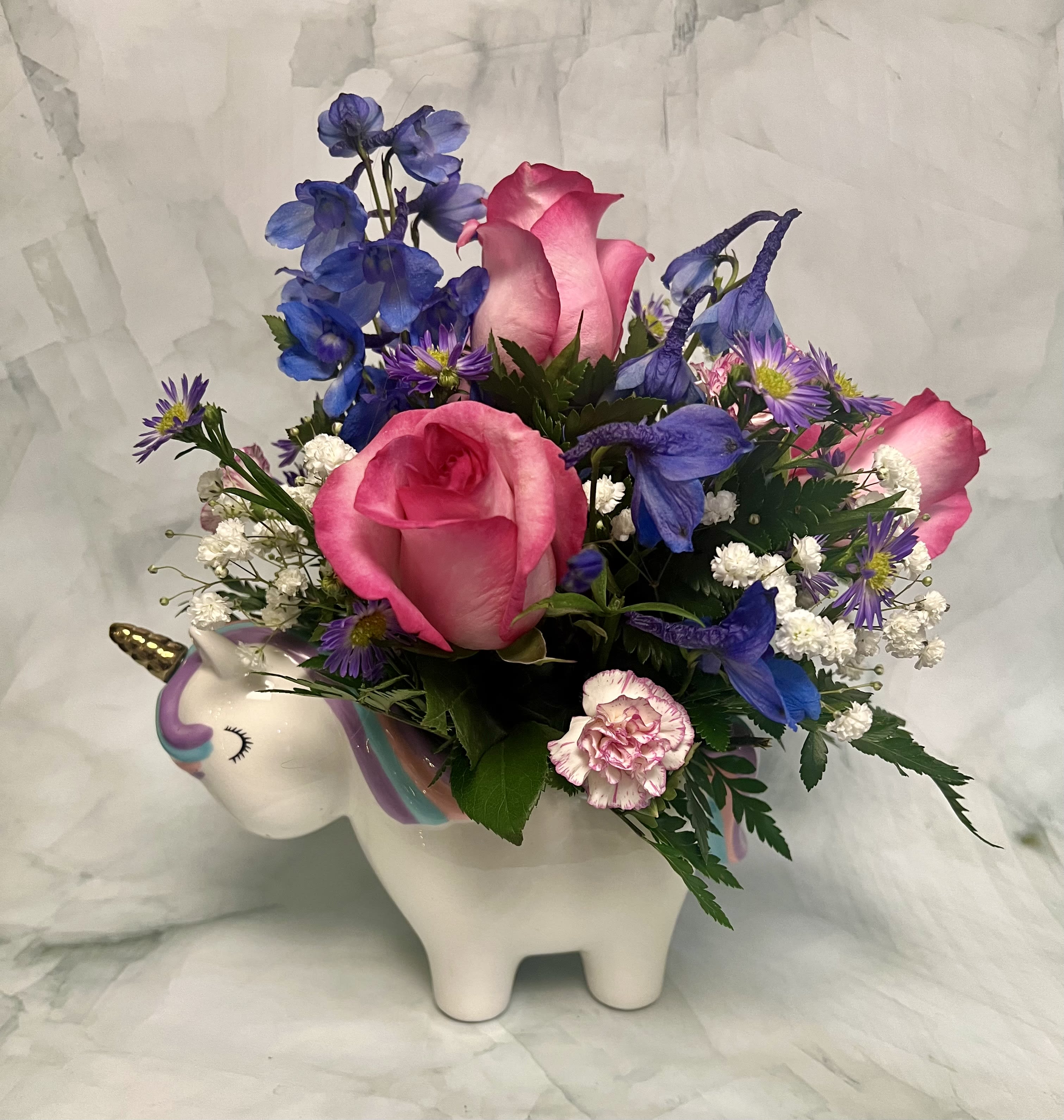 Magical Unicorn Garden  - This magical arrangement is made is this gorgeous unicorn planter that makes the perfect keepsake. The flowers used are Roses, Delphinium, Babies Breath, Aster and Carnations.
