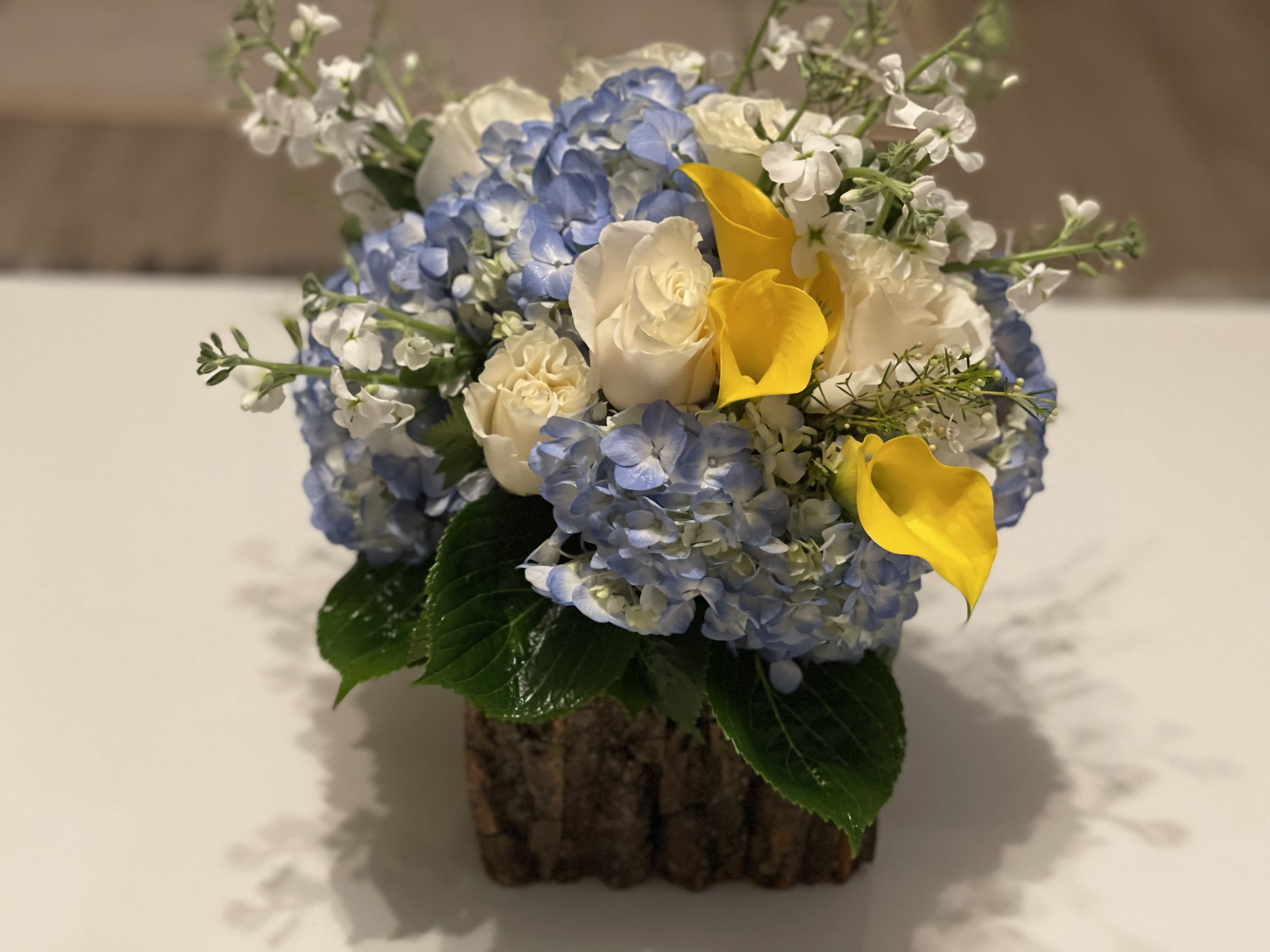 Angelina - Perfect floral arrangement to express how you care. Hydrangeas,calla lilies,roses and foliage.