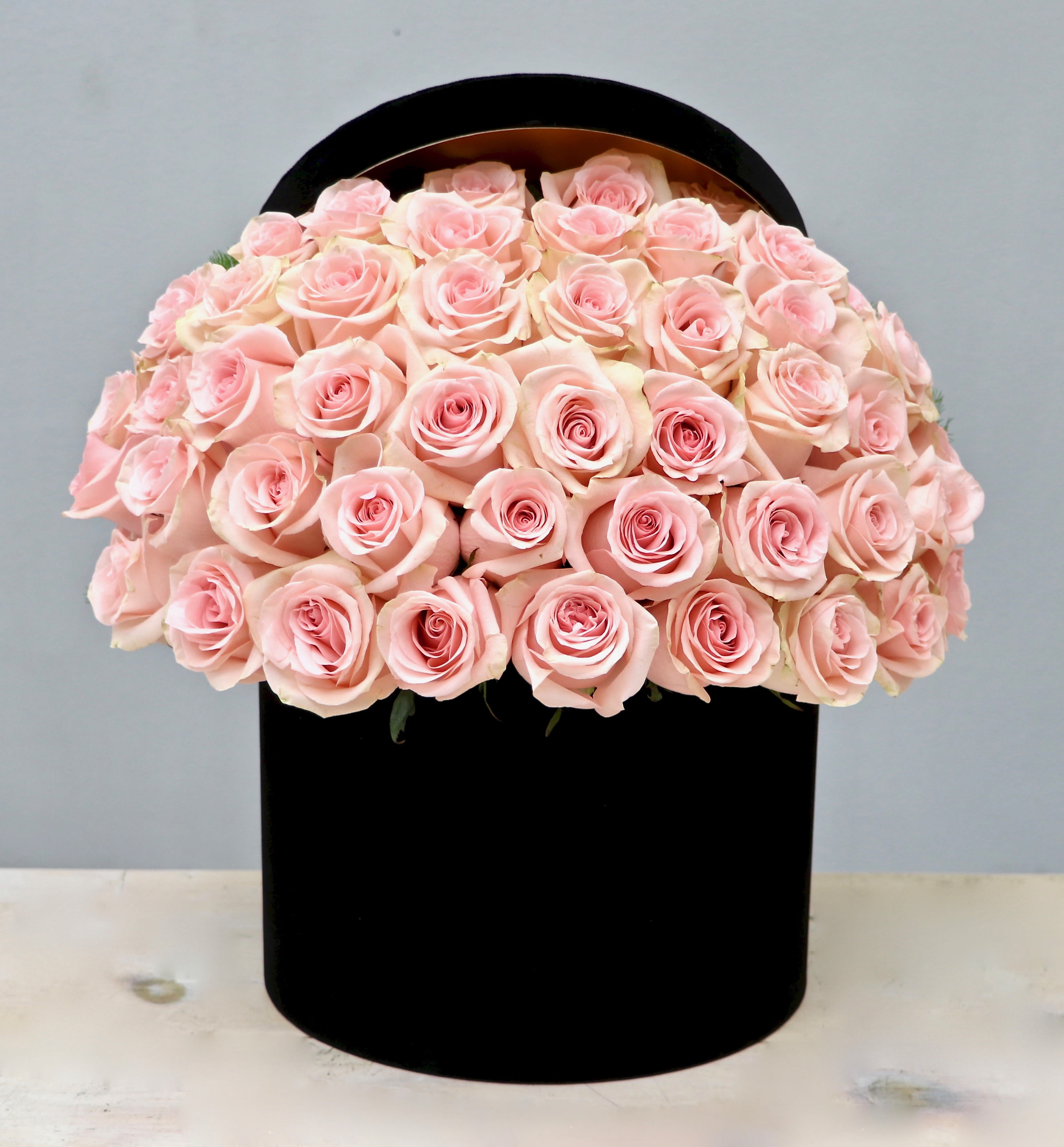 50 Pink Roses Black Hat Box- My Glendale Florist  - 50 Premium Ecuadorian pink roses perfectly arranged in our new hatbox! Make sure to upgrade to deluxe(75 roses) or premium(100 roses) for more roses!!  