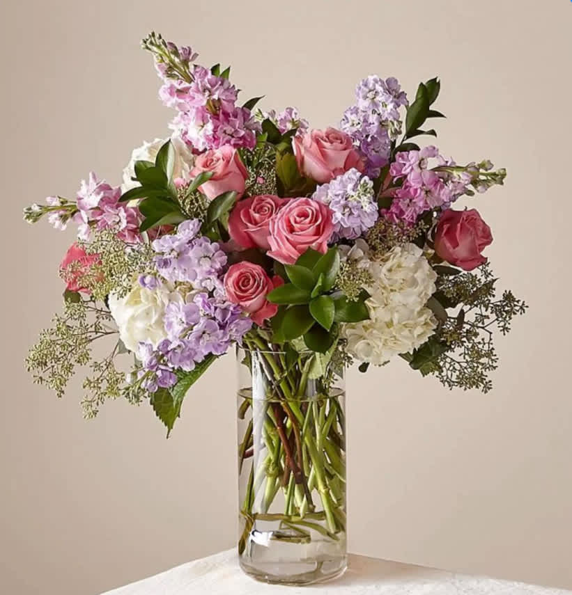In the Gardens Luxury Bouquet - Take a walk in the gardens with this sophisticated bouquet. Composed of an abundance of pastel florals and elegant texture in one of our signature vases, this arrangement brings natural beauty to anywhere it's placed. 