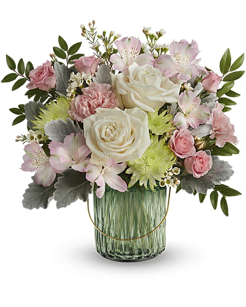 Teleflora's Lush Garden Bouquet - Fresh from the garden, this special refreshing rose bouquet is arranged in a glorious sage green glass lantern with golden handle and embossed design. This arrangement features crème roses, pink spray roses, pink alstroemeria, pink carnations, green cushion spray chrysanthemums, white waxflower, dusty miller and huckleberry. This bouquet is delivered in Teleflora's Lush Garden Lantern, which can be used as a lovely votive or piece of décor. Orientation: All-Around  SUBSTITUTION POLICY – Always deliver the freshest flowers! Please note the bouquet pictured reflects our original design.  If the exact flowers or container in this arrangement are not available, our local florists will create a beautiful bouquet with the freshest available flowers. 