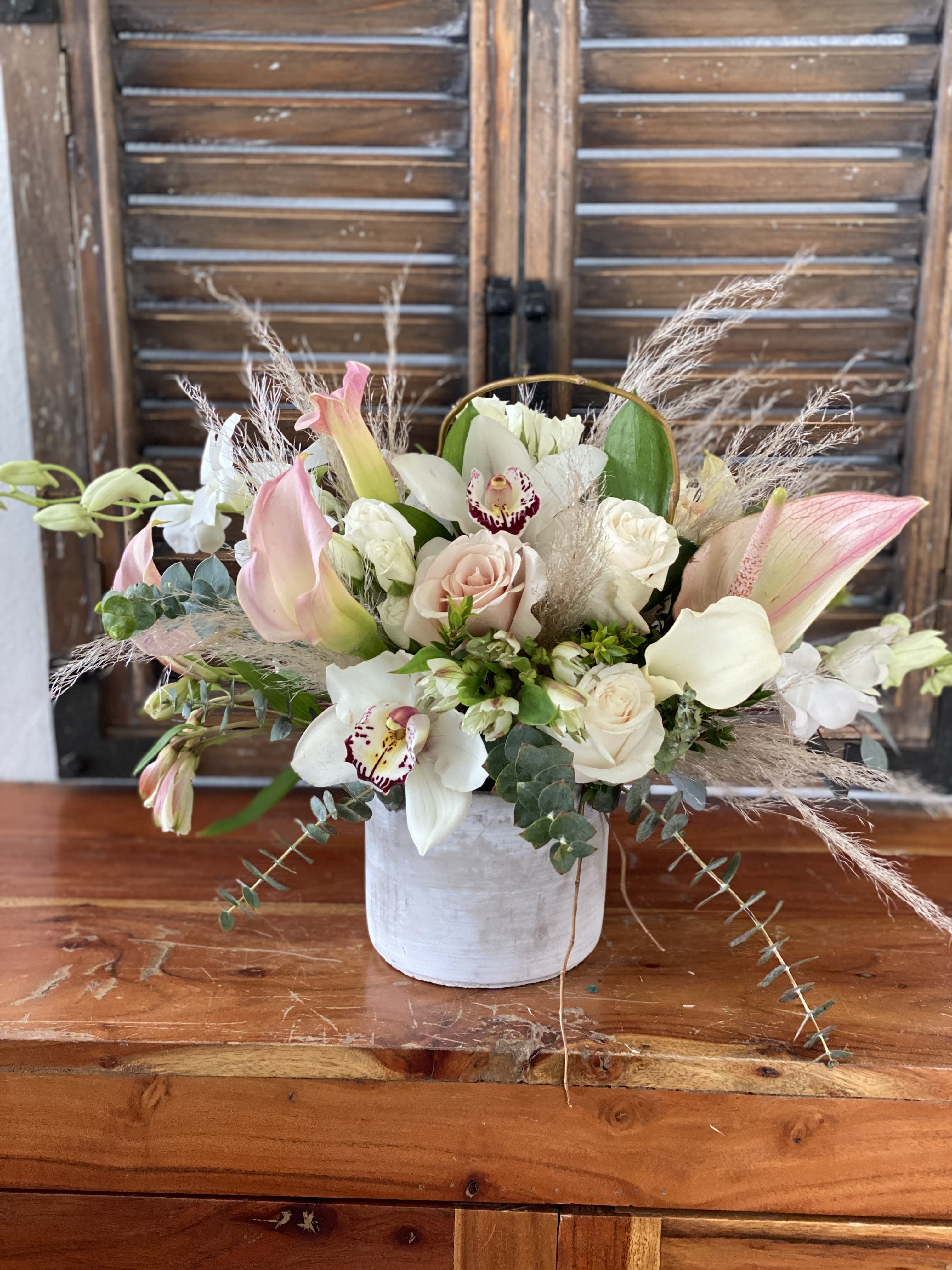 Softness  - Rustic cement container with soft bouquet in whites and pinks.