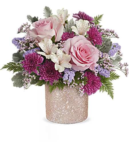 Teleflora's Blooming Brilliant Bouquet - Add a touch of sparkle to Mom's day with Teleflora's Blooming Brilliant cylinder, boasting a crushed glass texture and a soft ballerina pink hue, perfect for showcasing a dreamy Mother's Day bouquet.  Elevate mom's day with Teleflora's Blooming Brilliant cylinder, boasting a crushed glass texture in ballet pink, perfectly complementing a bouquet of pink roses, ivory alstroemeria, purple cushion spray chrysanthemums, lavender sinuata statice, pink limonium, dusty miller, and leatherleaf fern, a dazzling Mother's Day surprise. Standard size approximately 14&quot; W x 12 1/2&quot; H