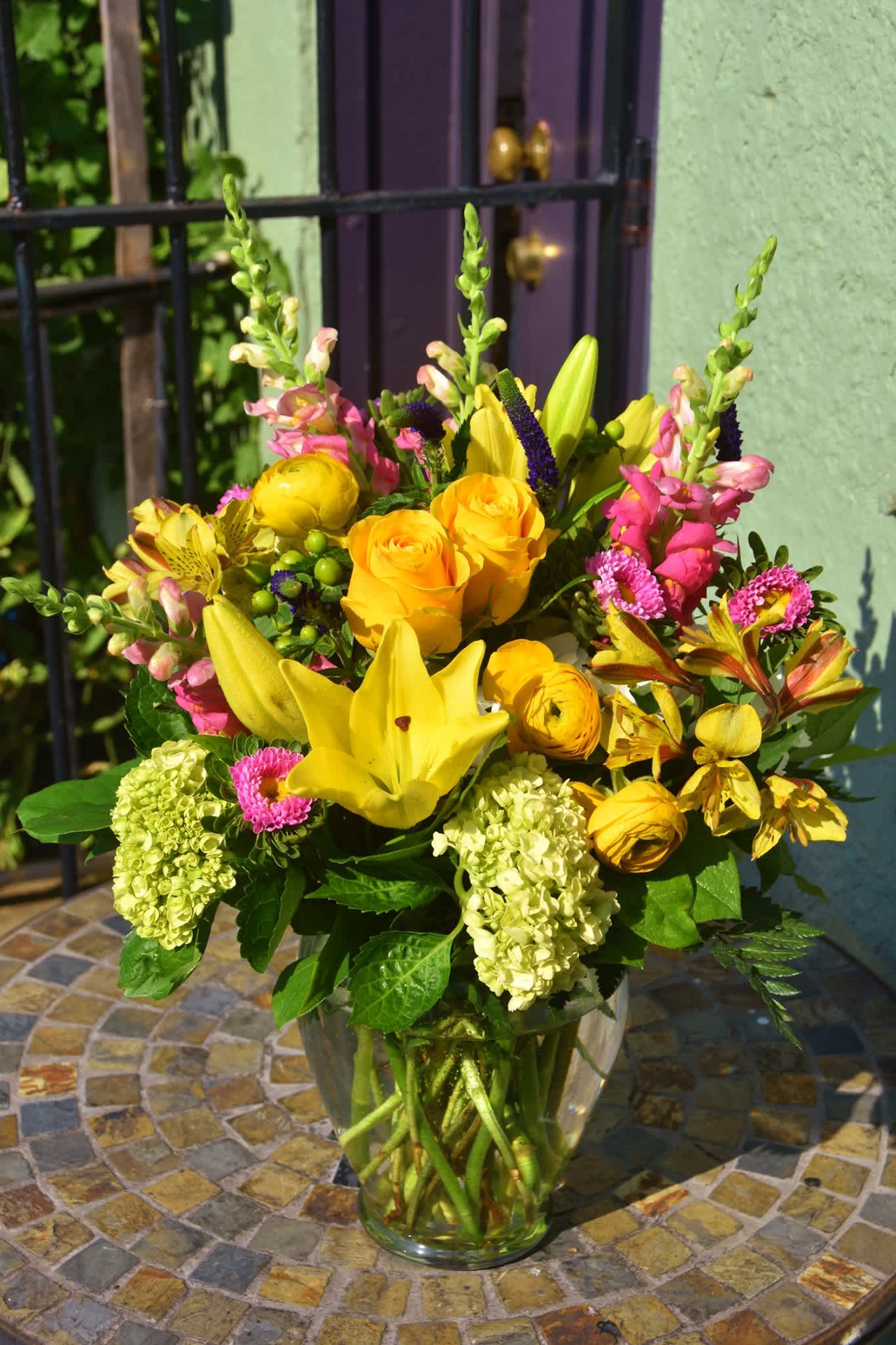 Sunday Sunshine - Bright sunshine flowers such as lilies, hydrangea, snapdragon, ranunculus, are designed in glass vase. Send a happy vibe to someone who needs them now!