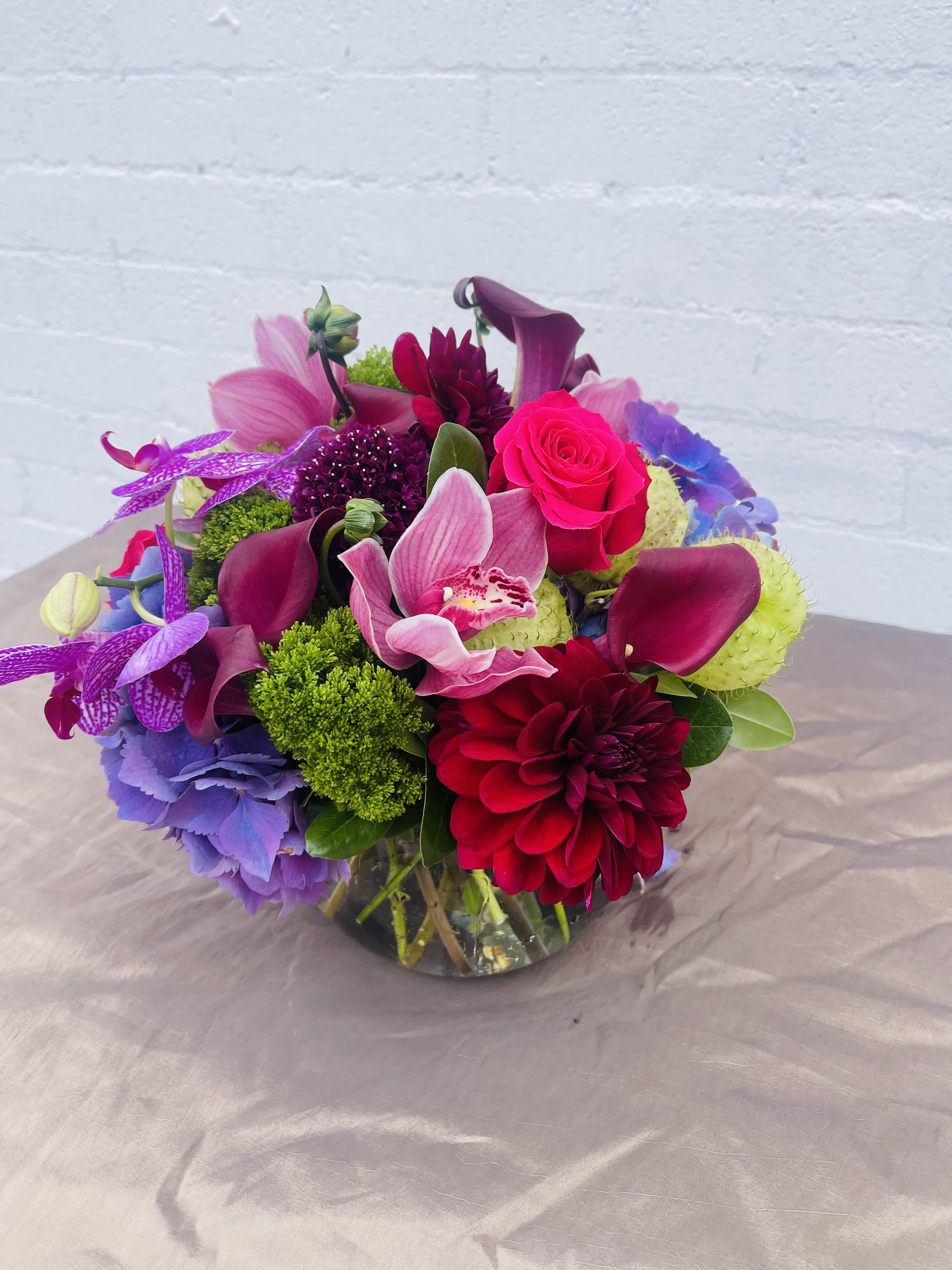 Small fish bowl - This luscious fishbowl comes with Cymbidium and lush garden  flowers. African calla lilies , dahlia, hydrangea and garden roses. 
