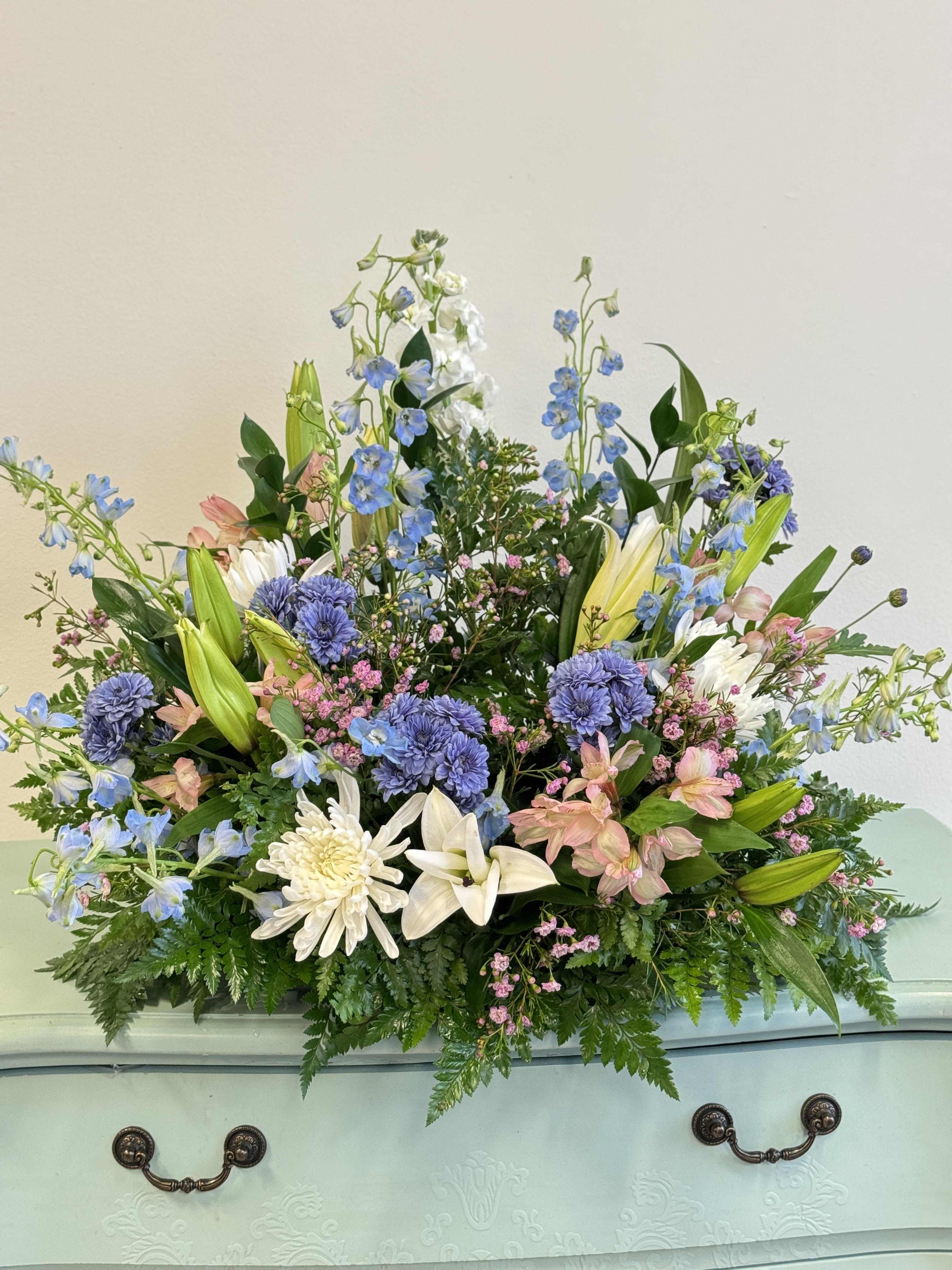 Urn Display - Hints of blue, white and pink colors elegantly adorn the cremation urn. 