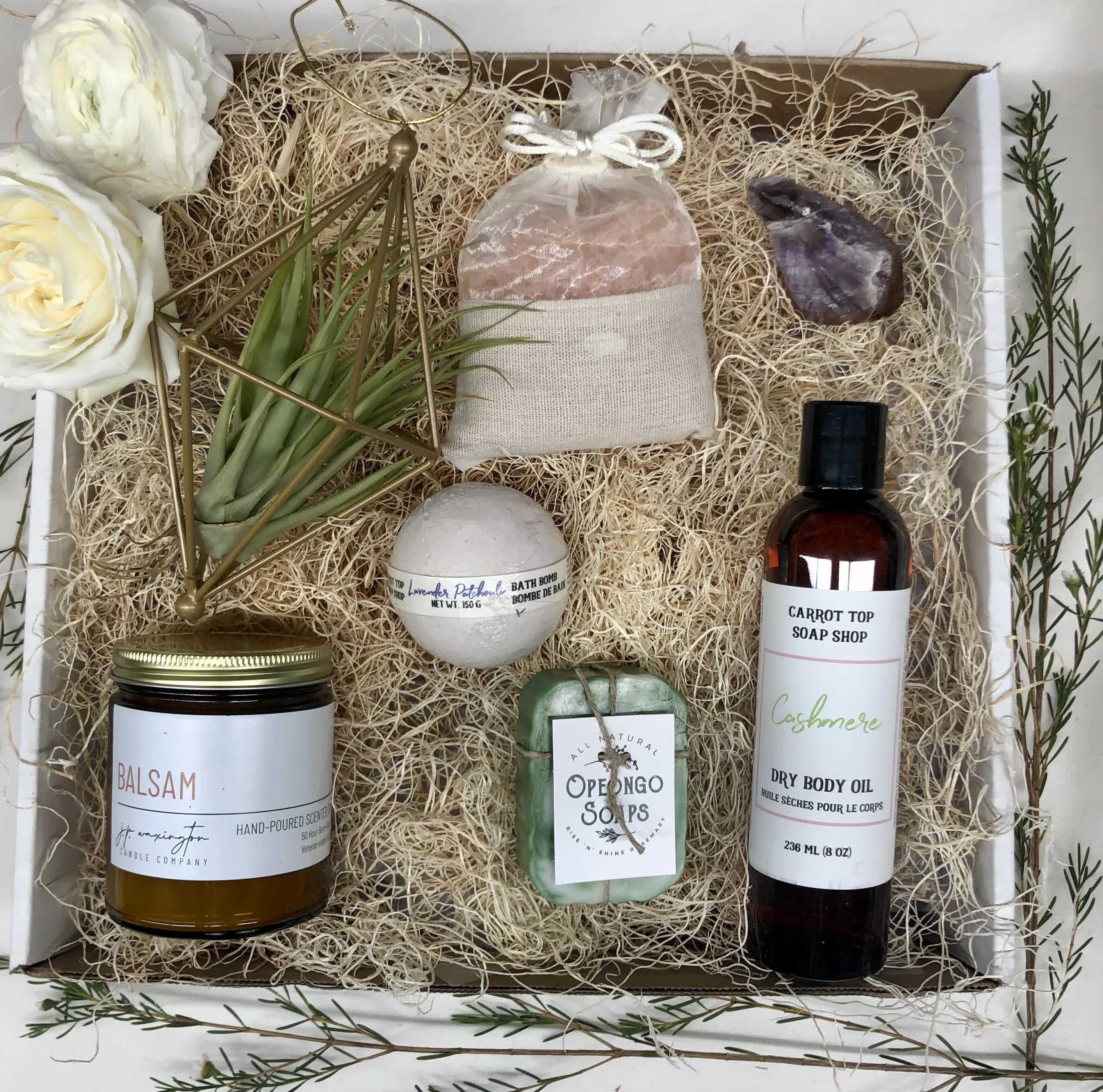FRESH AND CLEAN BATH GIFT BASKET - A luxurious bath gift basket to pamper the one you love. Featuring a locally made products such as a candle, bath bomb, soap, and body oil, and completed with bath salts, soap dish, a loofa and an air plant. Deluxe value pictured  