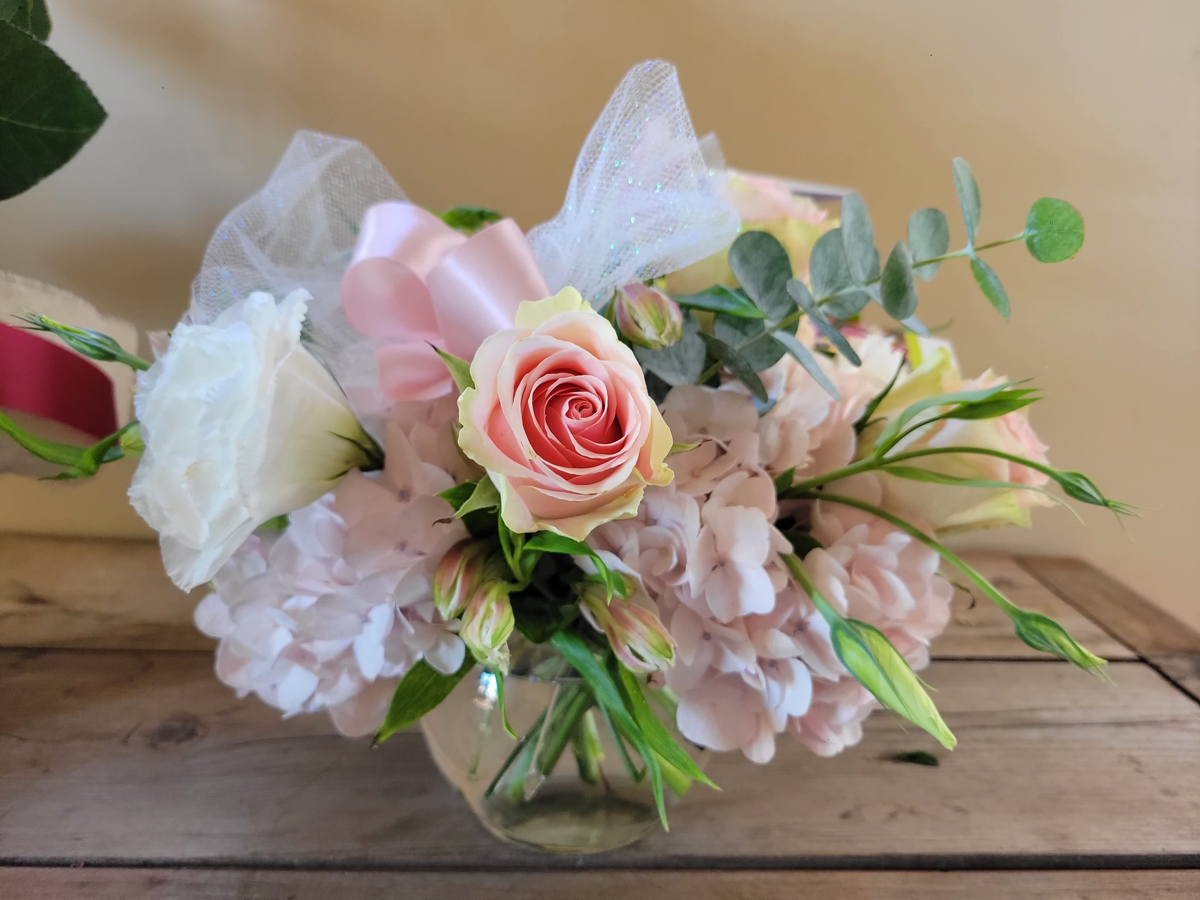 Pastel bubble - This &quot;Pastel Bubble&quot; arrangement comes delivered with pink or white hydrangeas pink roses, white lisianthus, and spiral eucalyptus with a feathery tulle ribbon. Presented in a clear glass bubble. This arrangement practically floats with its way to your loved one's doorstep.  This arrangement includes 3 hydrangea stems, 3 rose stems and supporting florals and greens in shades of light pink and white. 