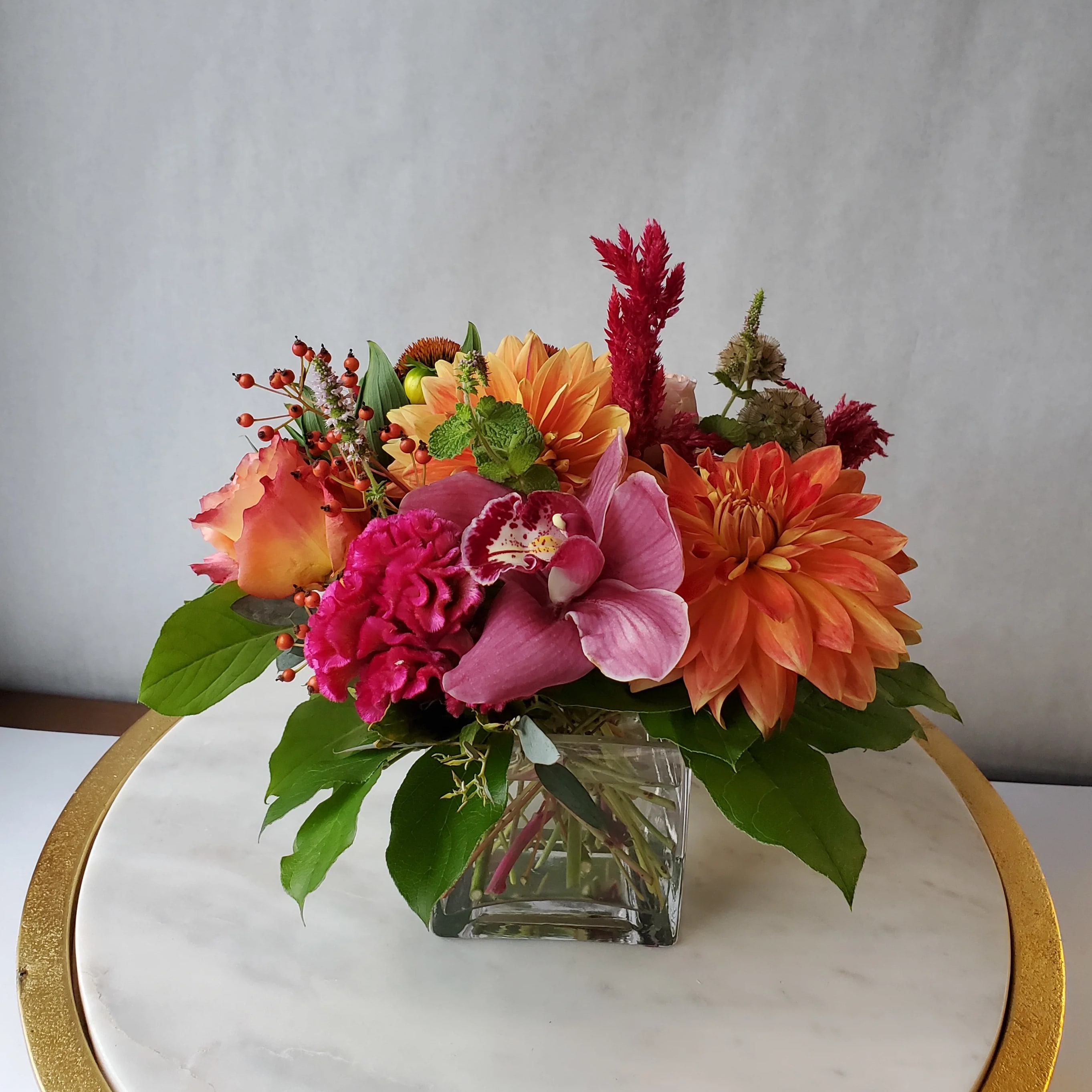 Dazzling Delight - Delight someone special, including yourself, today! By combining a vibrant mix of fiery reds, hot pinks, and bold oranges with the freshest seasonal flowers, this arrangement is sure to dazzle anyone.