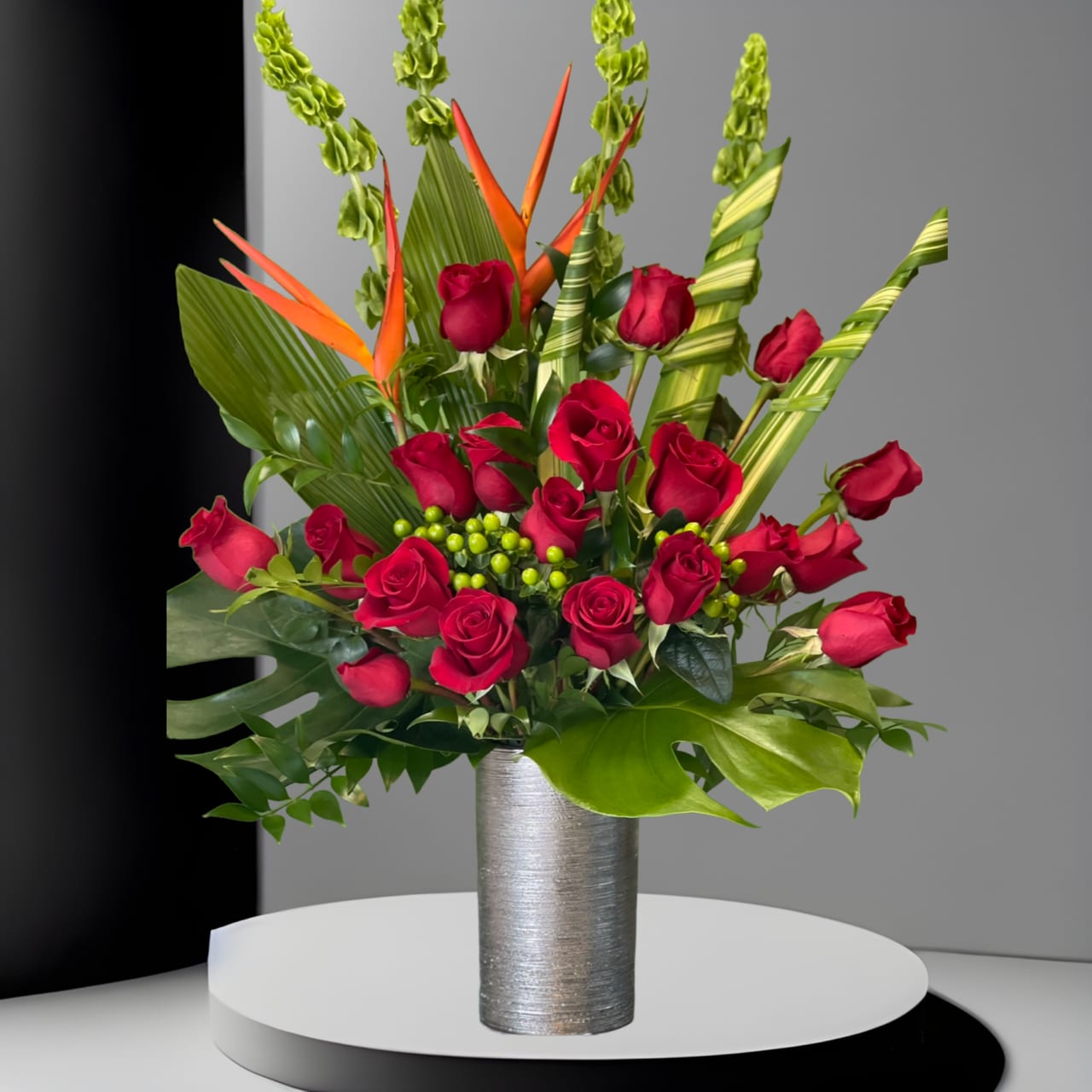 Artistic Artistic - Sculptural arrangement of tropical flowers and leaves, red roses, hydrangeas and birds of paradise, that make this arrangement unique and artistic!