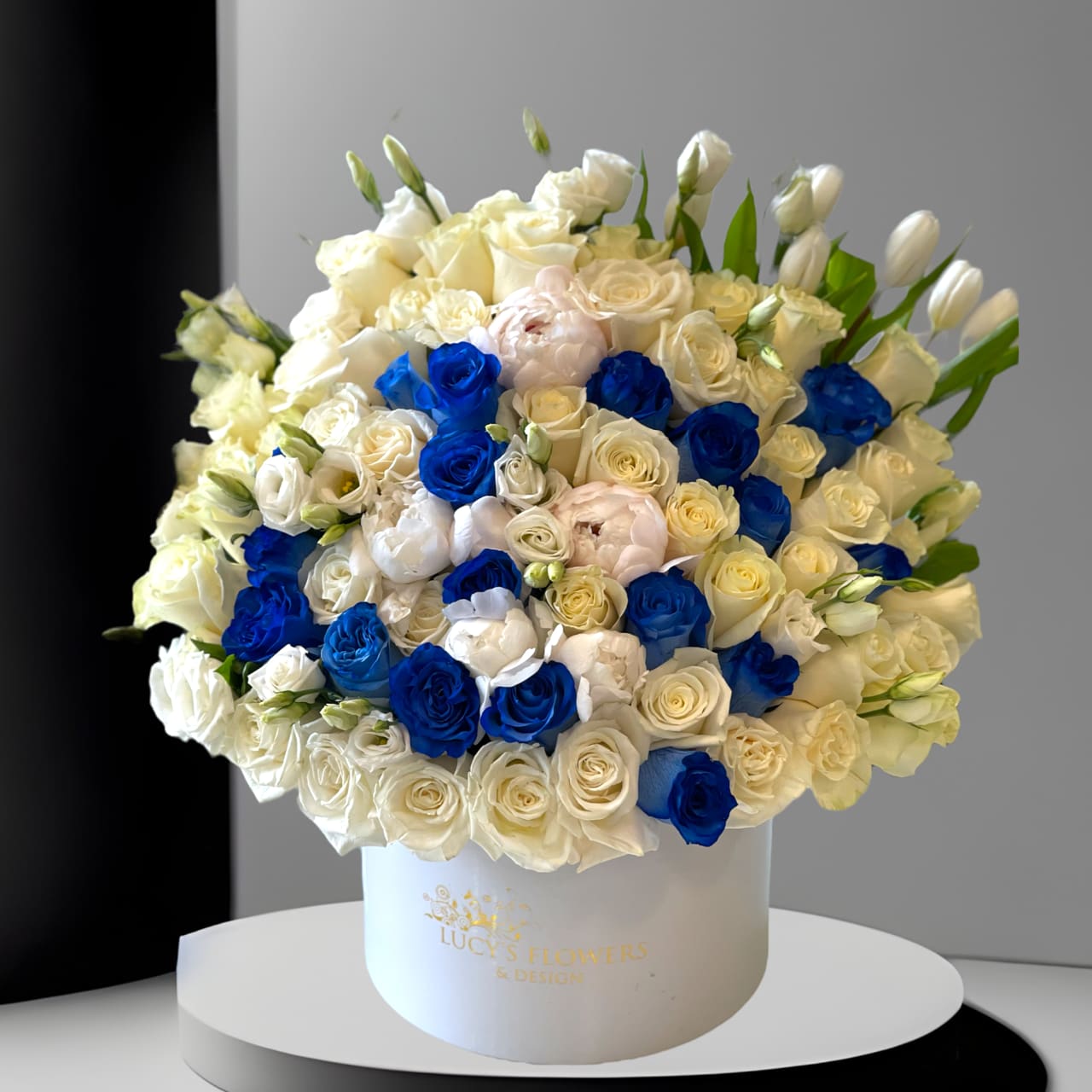 Best in Blue Best in Blue - Simple, yet such a unique and beautiful arrangement designed in our signature box with the most special blue roses that will make the recipient's day bright and cheerful! Arrangement Includes: -Fresh Cut Roses -Tulips, Lisianthus, Peonies -Lucy's Signature Large Box -Custom Greeting Card -Care Instructions