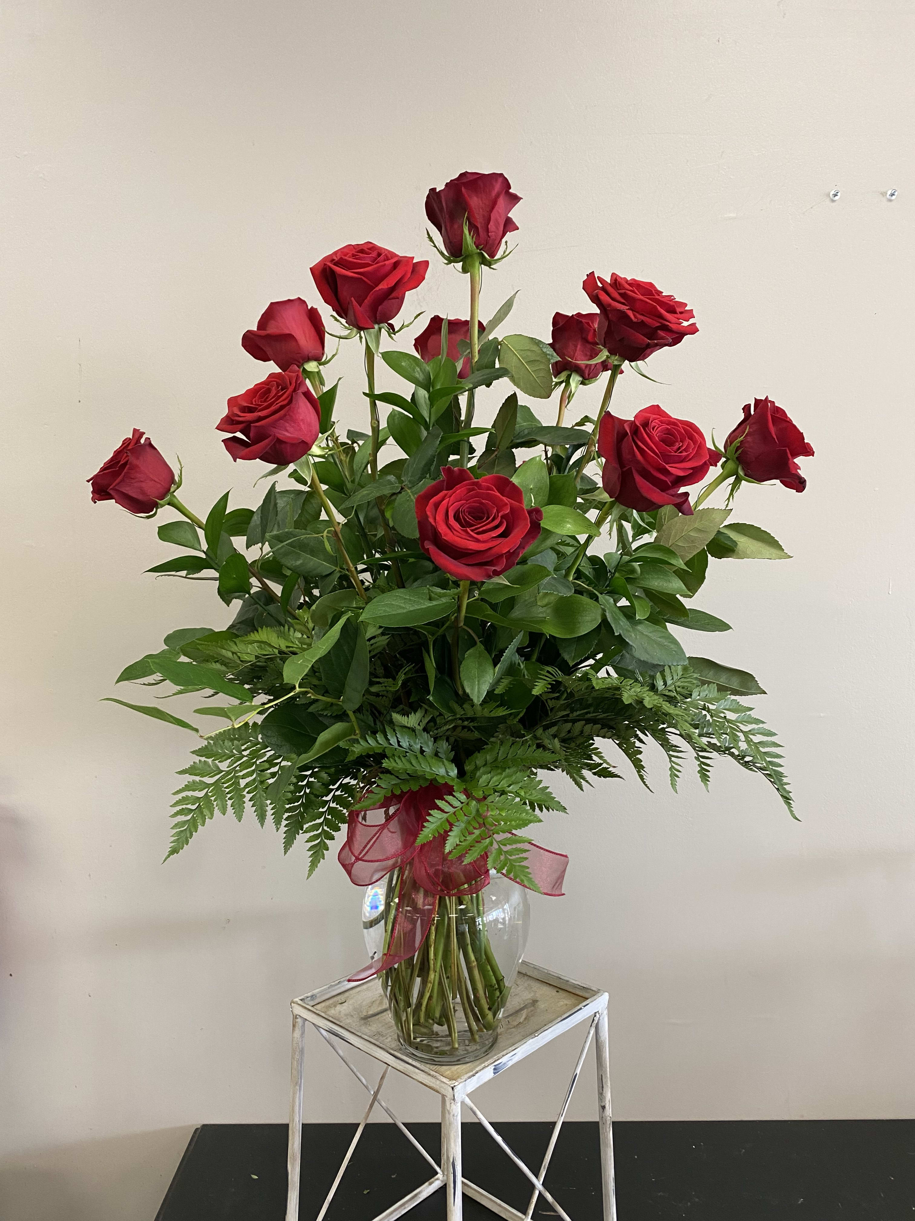 Dozen Long Stem Red Roses  - These dozen red roses with lush greenery are the classic romantic gift!   