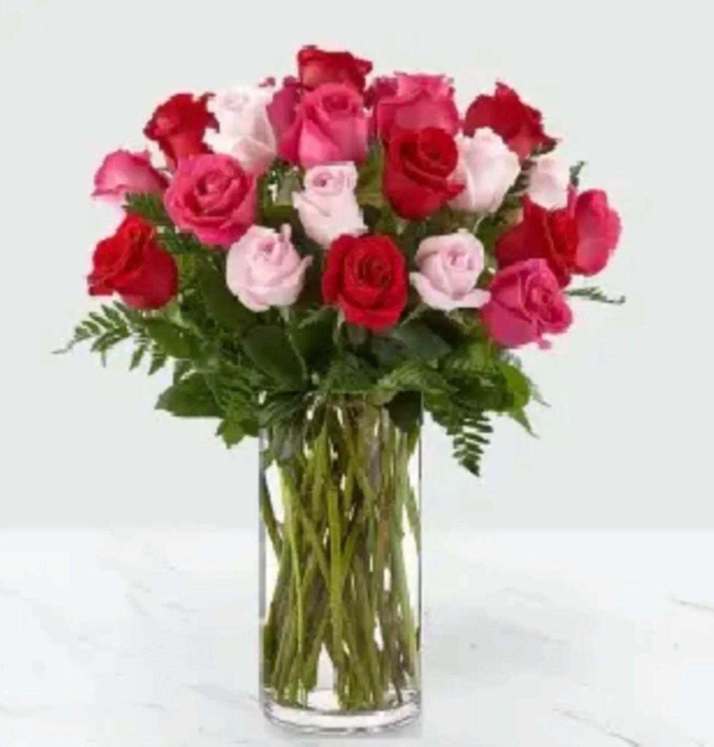 Rose Colored Love 24 - It's all in the name. This sweet arrangement is a soft and feminine combination of roses in three stunning shades. Each pink, hot pink and red bloom in our Rose Colored Love Bouquet is perfect for sending affection to a significant other or surprising a loved one with a gorgeous Valentine.