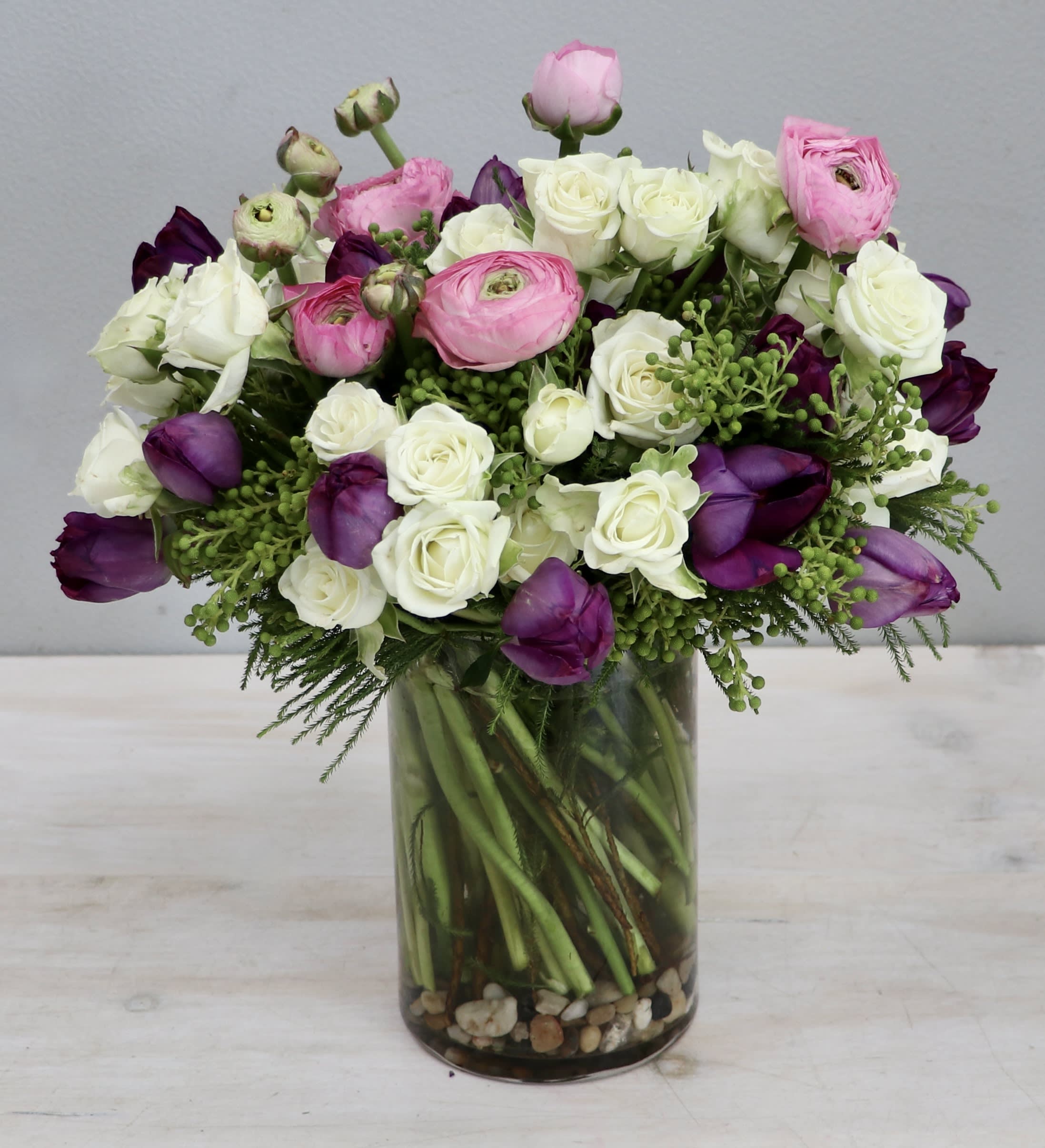 Simply Love - My Glendale Florist  - The arrangement features spray rose, ranunculus, and tulips for a sweet look. At standard size this arrangement is 12-14 inches tall and wide.
