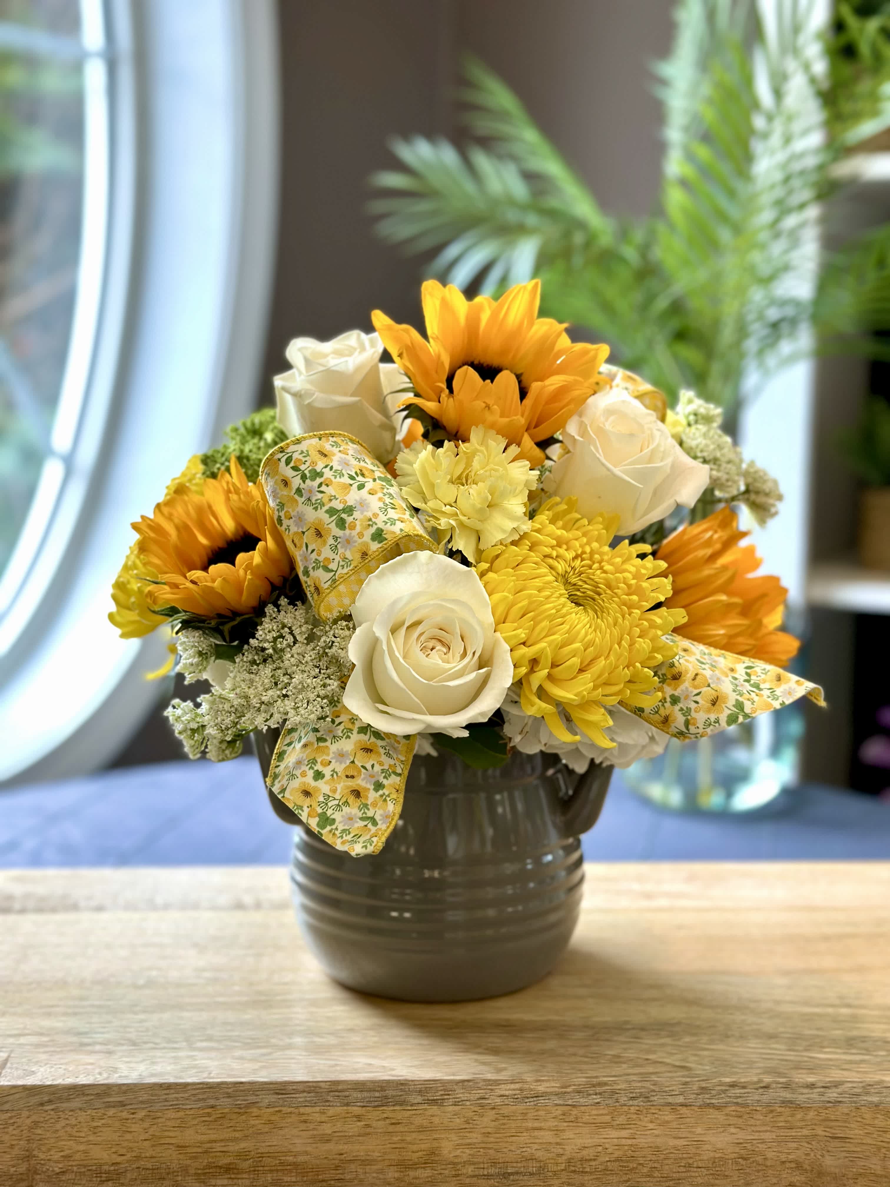 Homemade Memories - Mix of white and yellow fresh flowers that includes; sunflowers, roses, carnations, mums, with simple touches of greenery. Designed in a nice keepsake gray ceramic crock. FLOWERS &amp; COLORS MAY VARY! ONLY AVAILABLE FOR LOCAL DELIVERY!