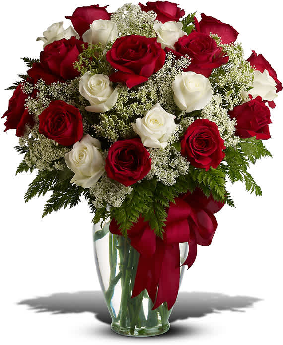 LOVE'S DIVINE BOUQUET - LONG STEMMED ROSES - Love's divine, and roses are too. At almost two feet tall, this beautiful mix of red and white roses - accented with Queen Anne's Lace, and adorned with a bold red ribbon - is a timeless gift for your beloved.  Red and white roses - accented with Queen Anne's lace and more - are delivered in a glass vase accented with a red satin ribbon.