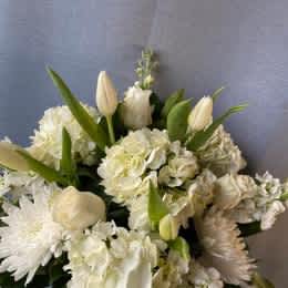 Timeless BQ. - Our all white compact, fresh flower arrangement in organic white and greens.in a low clear glass container
