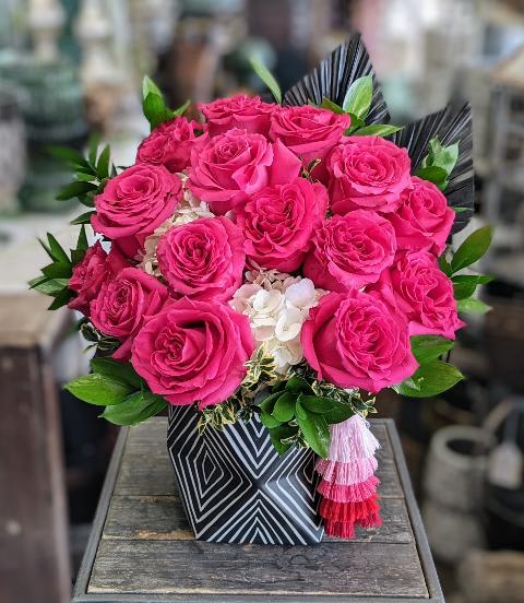 Ursula - Hot pink roses and white hydrangea arranged in a geometric black and white pot, accented with a tassel.