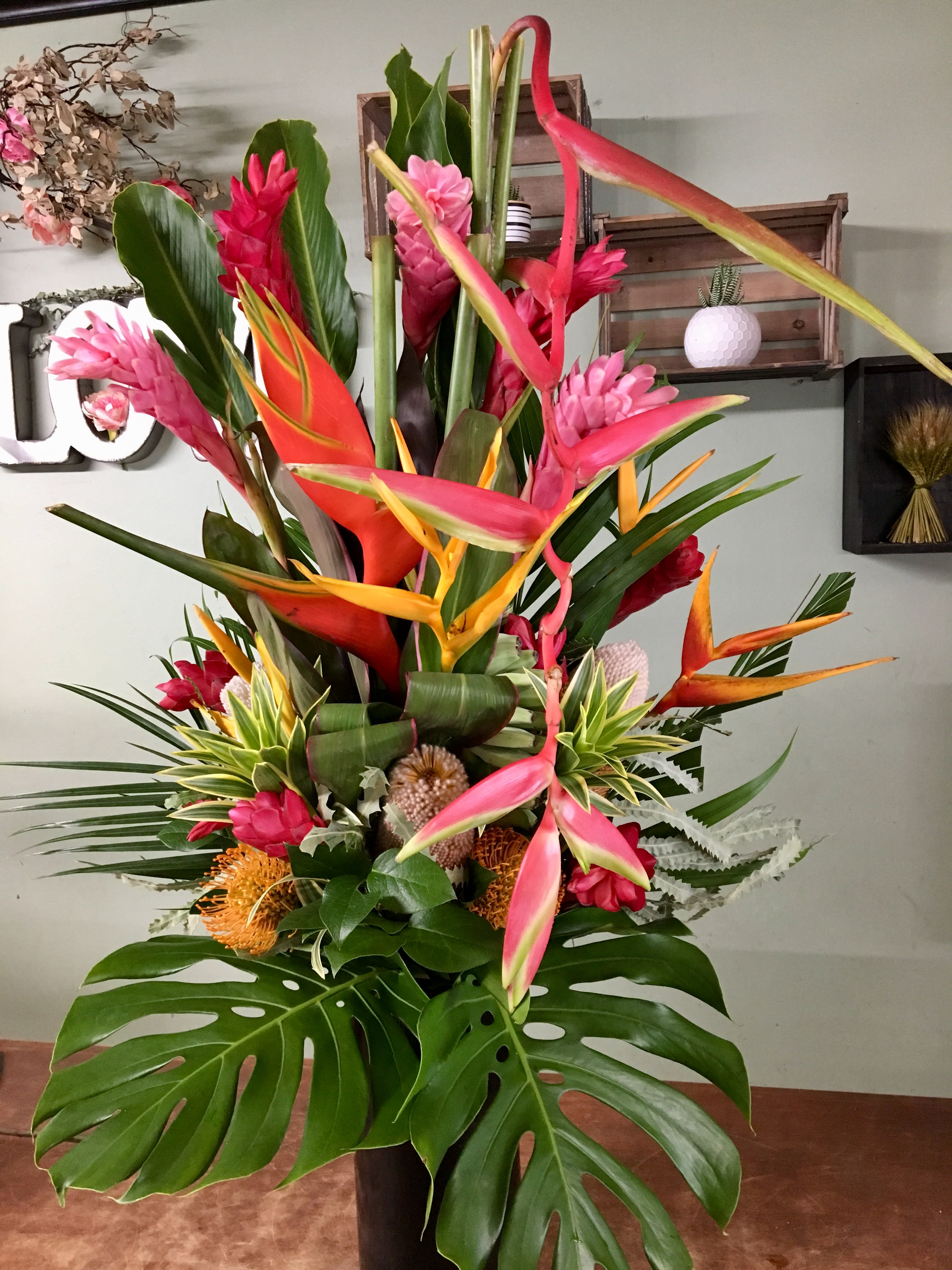Tropical Journey  - Gorgeous tropical arrangement with a variety of topical flowers arrange in a tall vase just what you need to brighten your heart. 