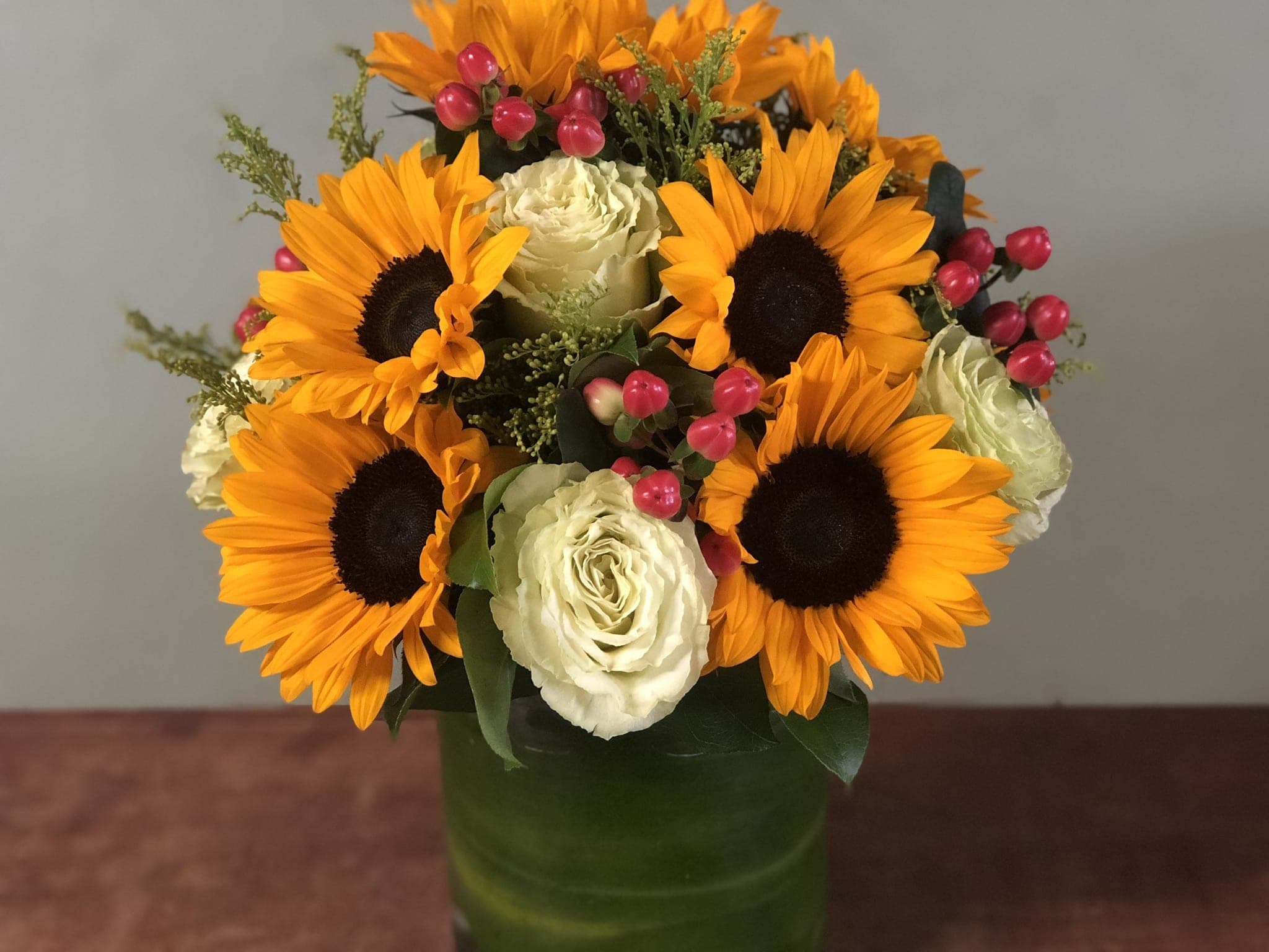Berry Berry Sunny Berry Berry Sunny - Sunflowers, coffee beans, roses and much more all beautifully arranged in a cylinder vase.