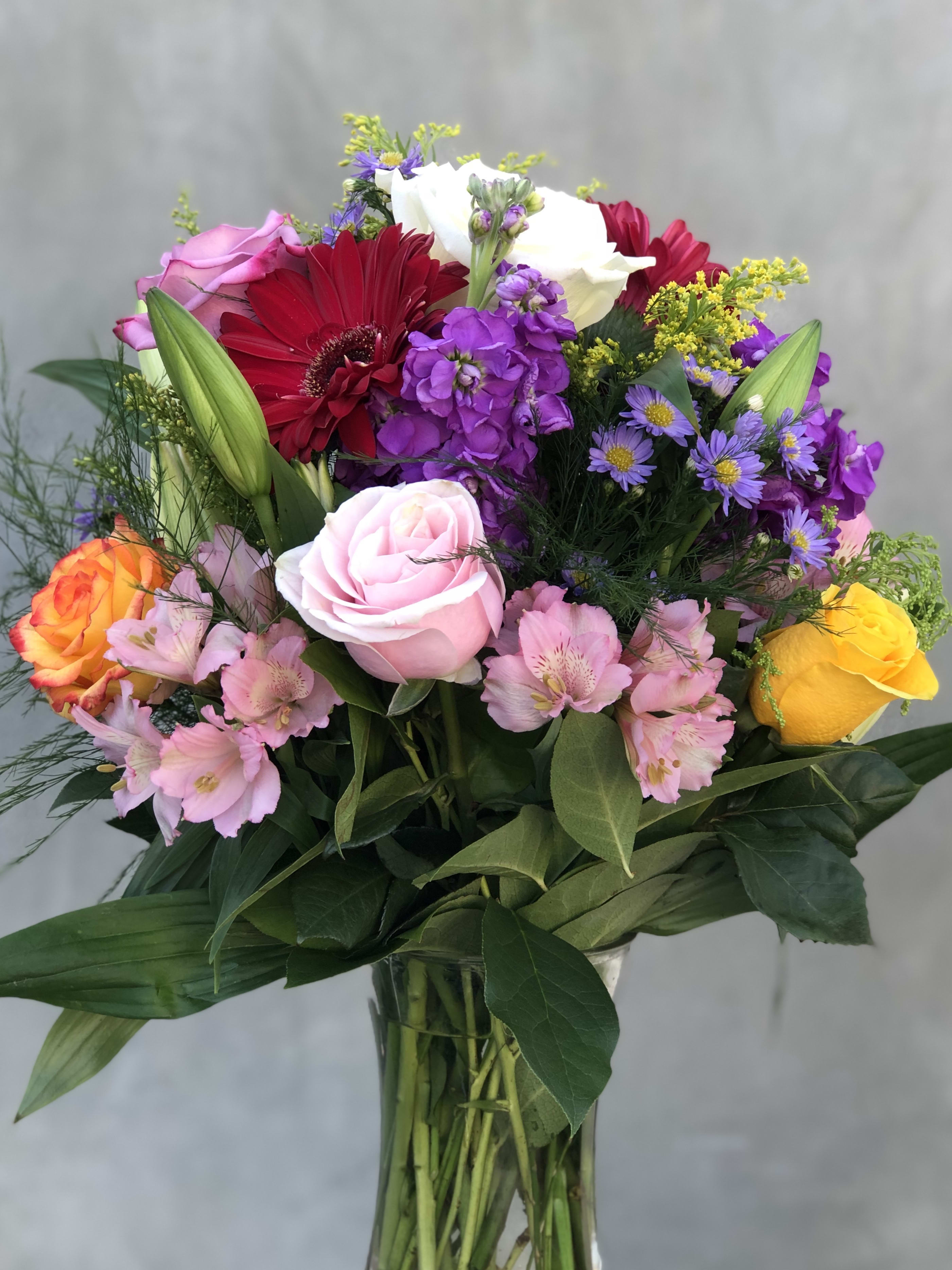 A Mix Of Beauty - Variety of mix flowers arranged and put together with love. All in a tall glass vase. 