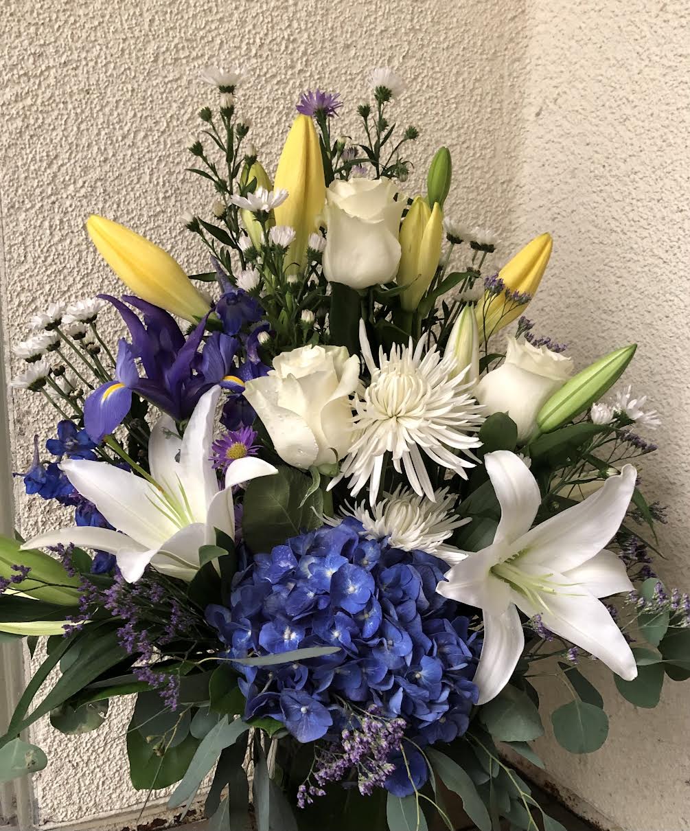 Eternal Sunshine Eternal Sunshine - Roses, Hydrangea, Blue Delphinium, Asitic Lyli, Casa Blanca in Glass Vase.