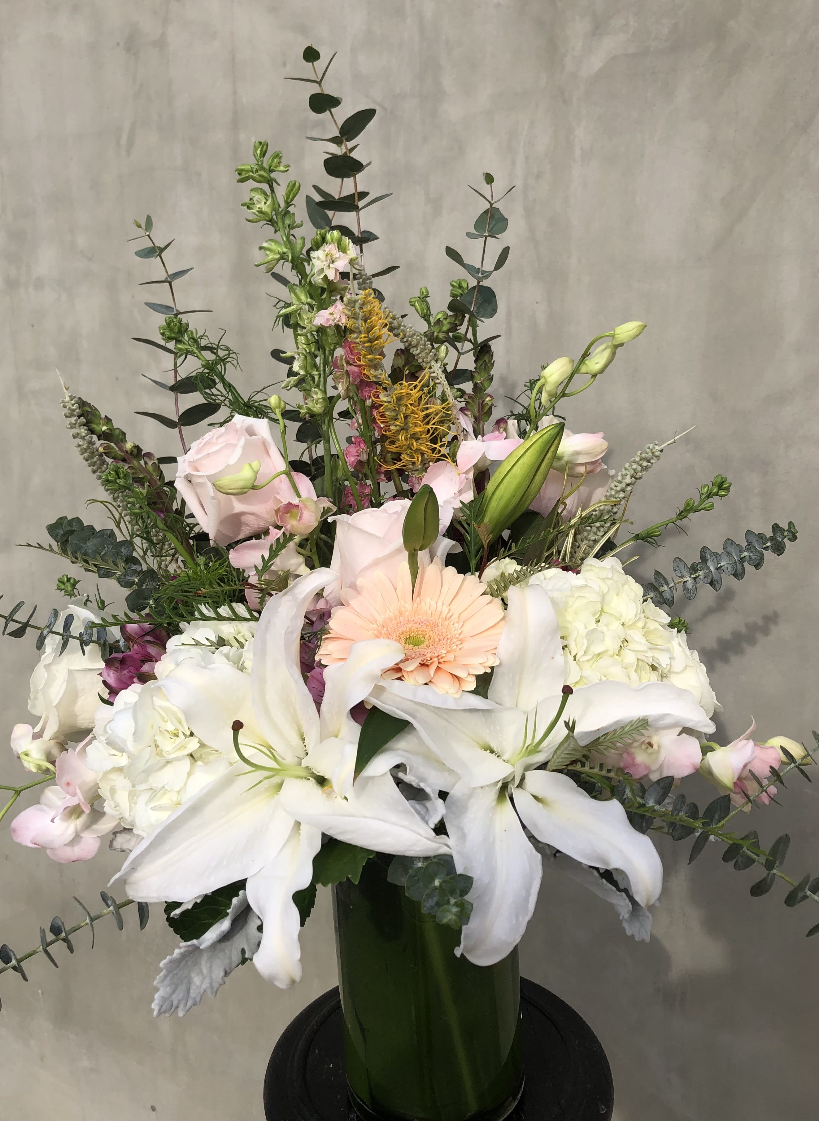 The Jewel In the Crown The Jewel In the Crown - Includes white lilies, roses, gerberas, hydrangeas, and many more, arranged in a glass vase.