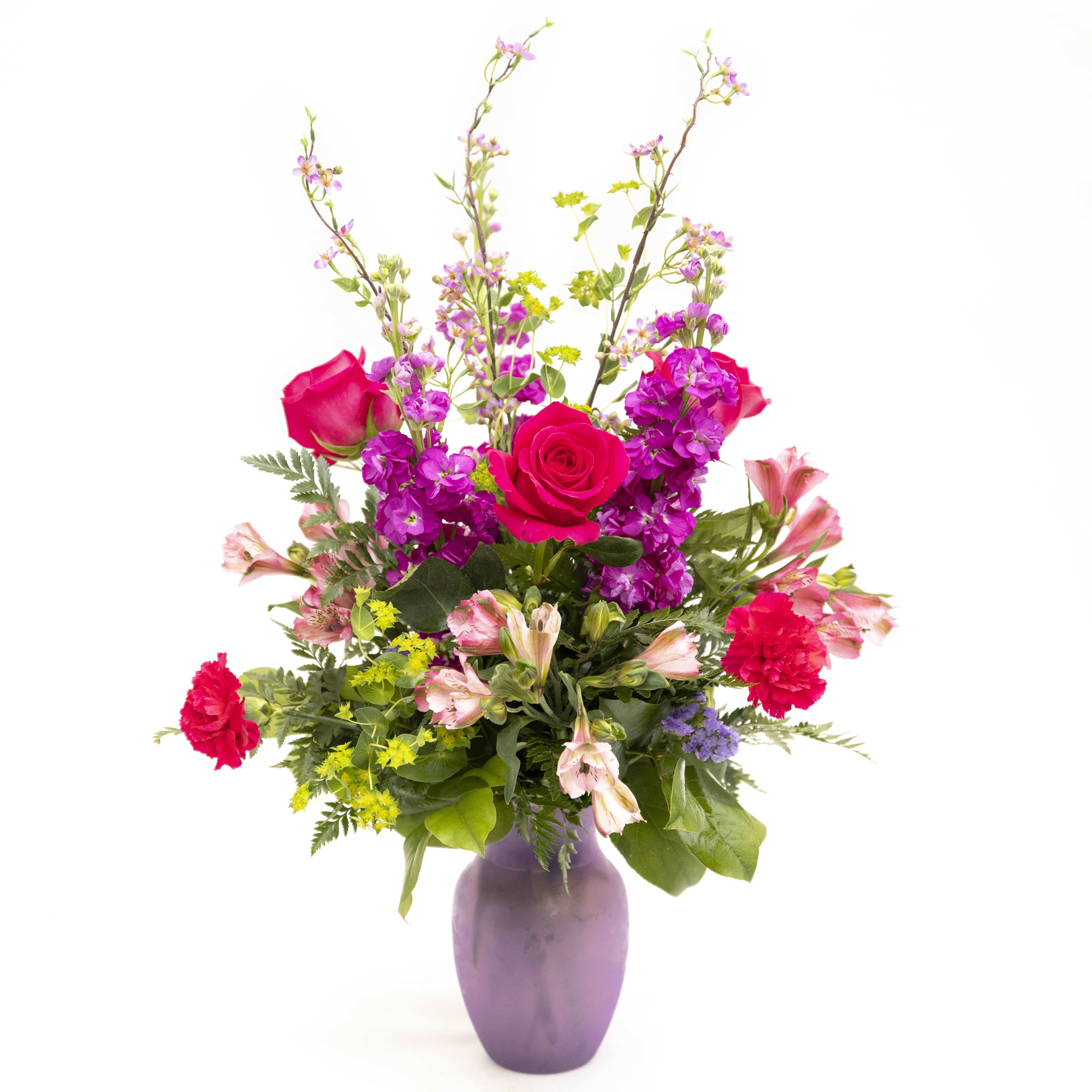 Love and Kisses, Mom! - Approximate Size: 27&quot;x 20&quot; This fun lavender vase is filled with fuscsia colored Stock, pink Alstroemeria, hot pink Roses, lavender Staice, hot pink Carnations and Bluplureum. 