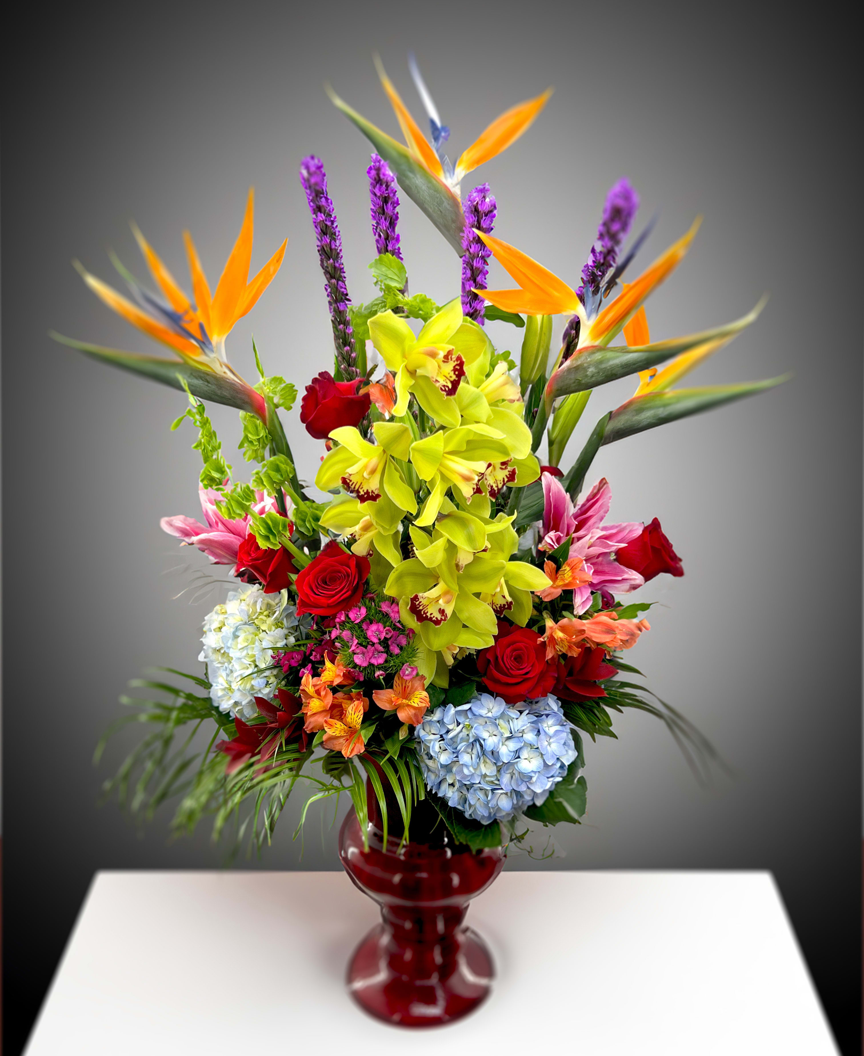 Flourish  - This is a gesture that is both bold and extravagant! A combination flowers including Birds Of Paradise, Cymbidium Orchids, Roses, Lilies, and other blooms