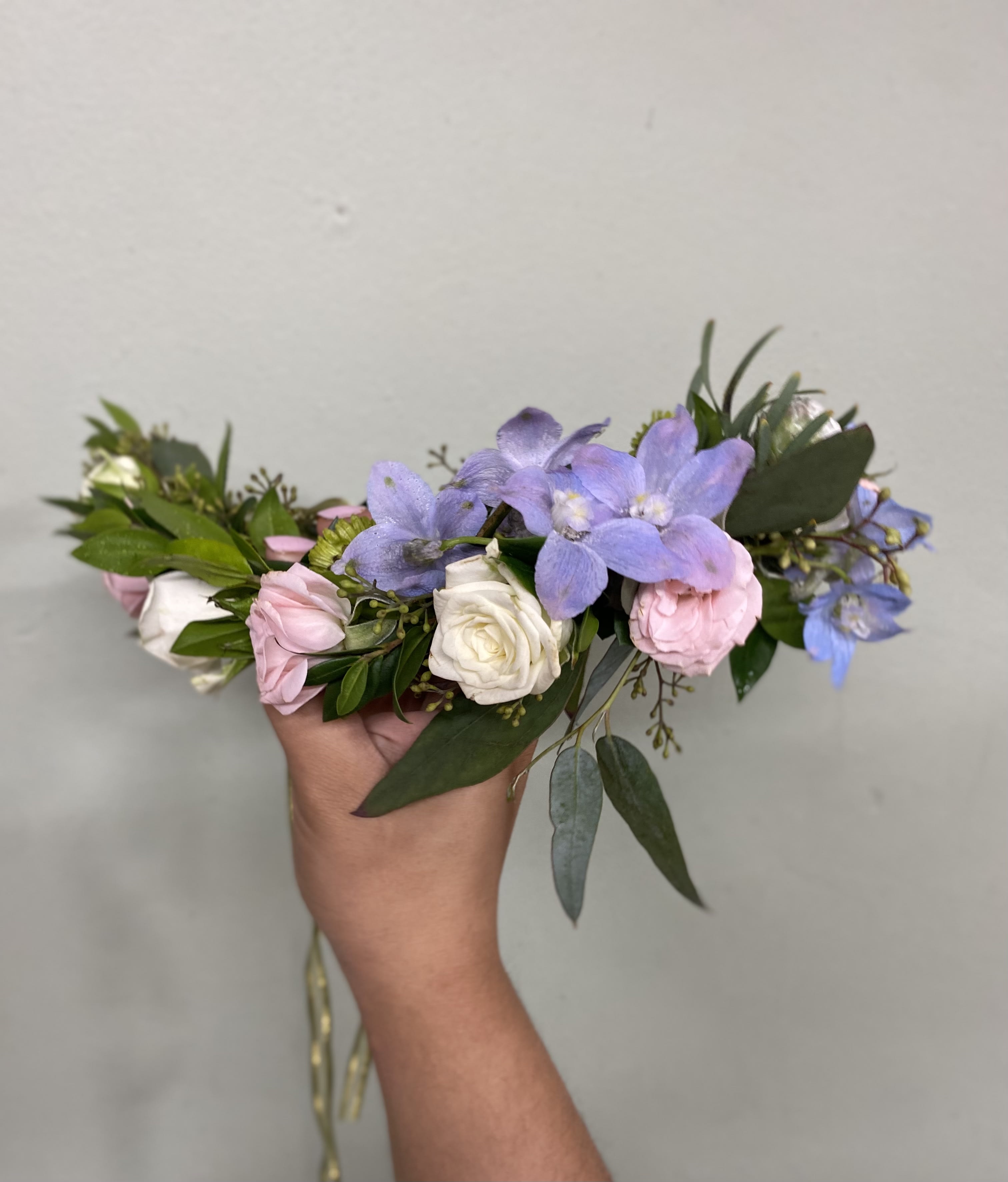 Wandering Free Flower Crown - A partial flower crown with greenery, spray roses, and delphinium tied with a ribbon. 