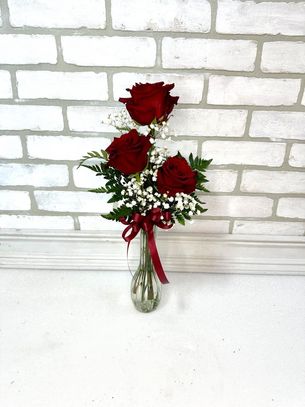Classic Three Red Roses - A simple yet elegant expression of love and appreciation in a trio of red roses. Call for availability of other colors. 