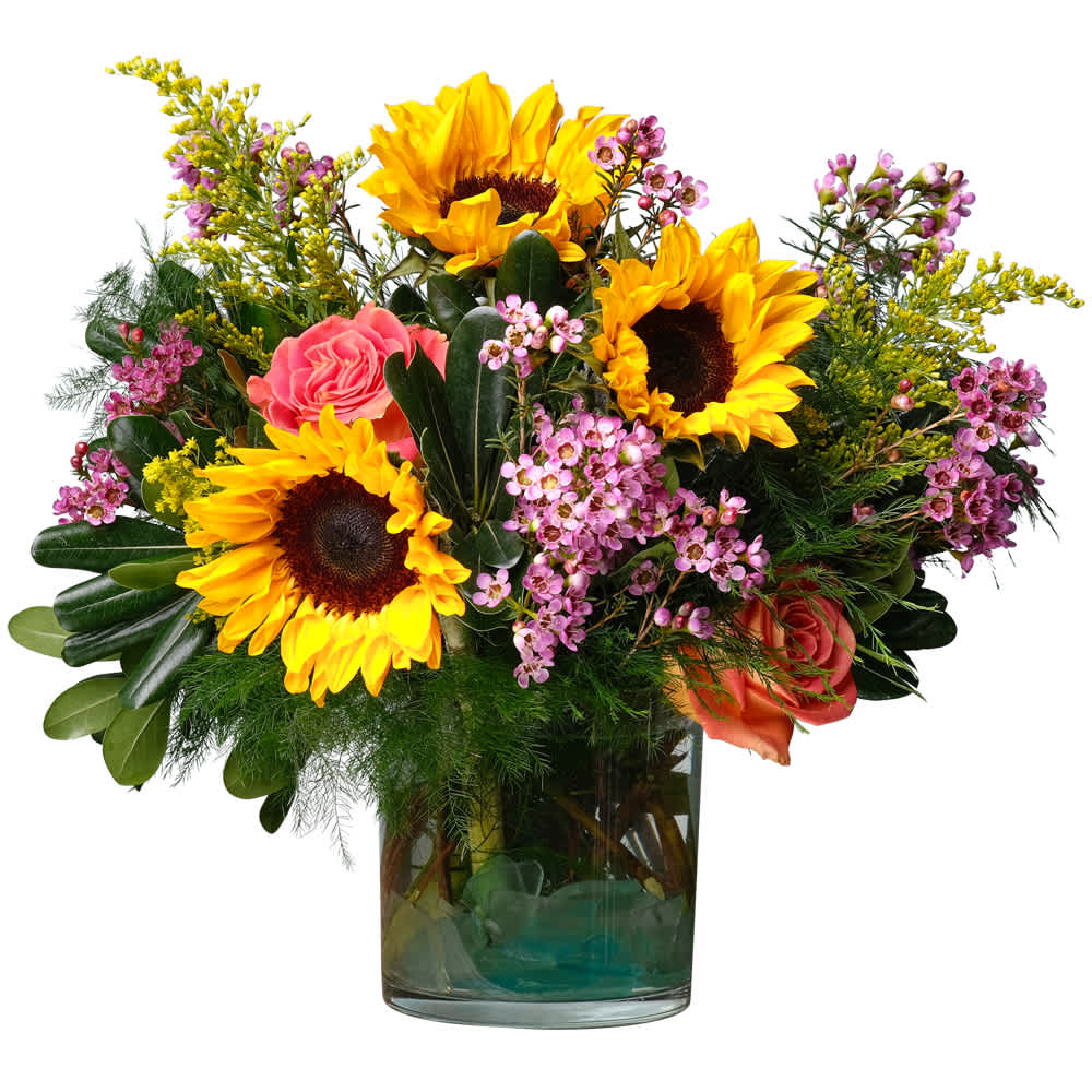 Fab You! - Brightly colored flowers like sunflowers, roses, solidago and wax flower are complimented by dark green foliage. The clear vase is a perfect compliment to the colors in the arrangement. This design says, &quot;You are fabulous!&quot; DGTMF-1356