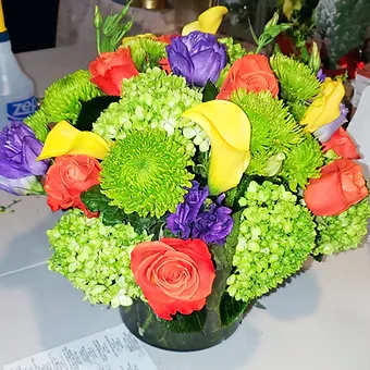 Enchanted - Large arrangmen of green emerald mini hydrangea, a dozen roses, calla lily and lisianthus. Bright and cheerful.