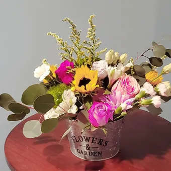 Petit Noir Petit Noir - Lovely flower pot arrangment with a variety of seasonal flowers.