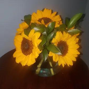 Sunset - 6 large sunflowers ina crystal buble vase with ruscus greenery.